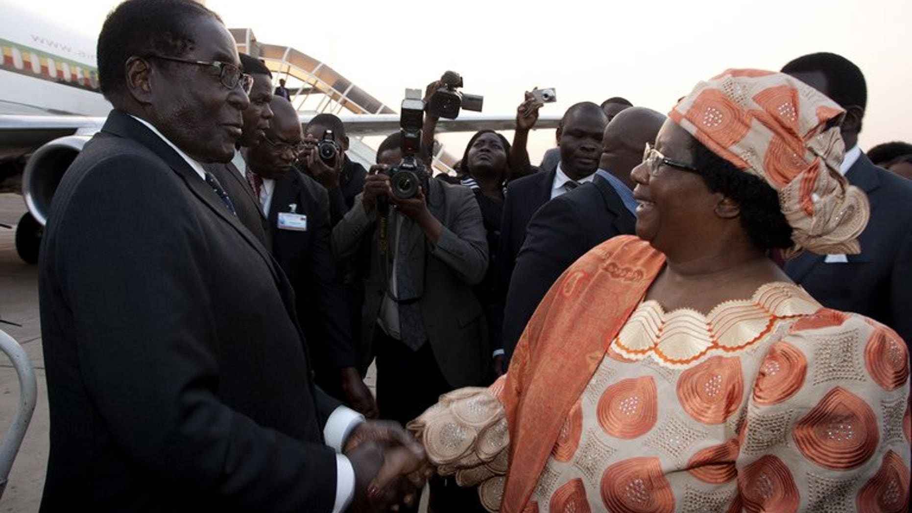 Malawi President Joyce Banda welcomes Robert Mugabe at Kamuzu Airport in Lilongwe on Friday. Southern African leaders opened an annual summit Saturday endorsing disputed elections in Zimbabwe that extended Mugabe's 33-year rule by another five years.
