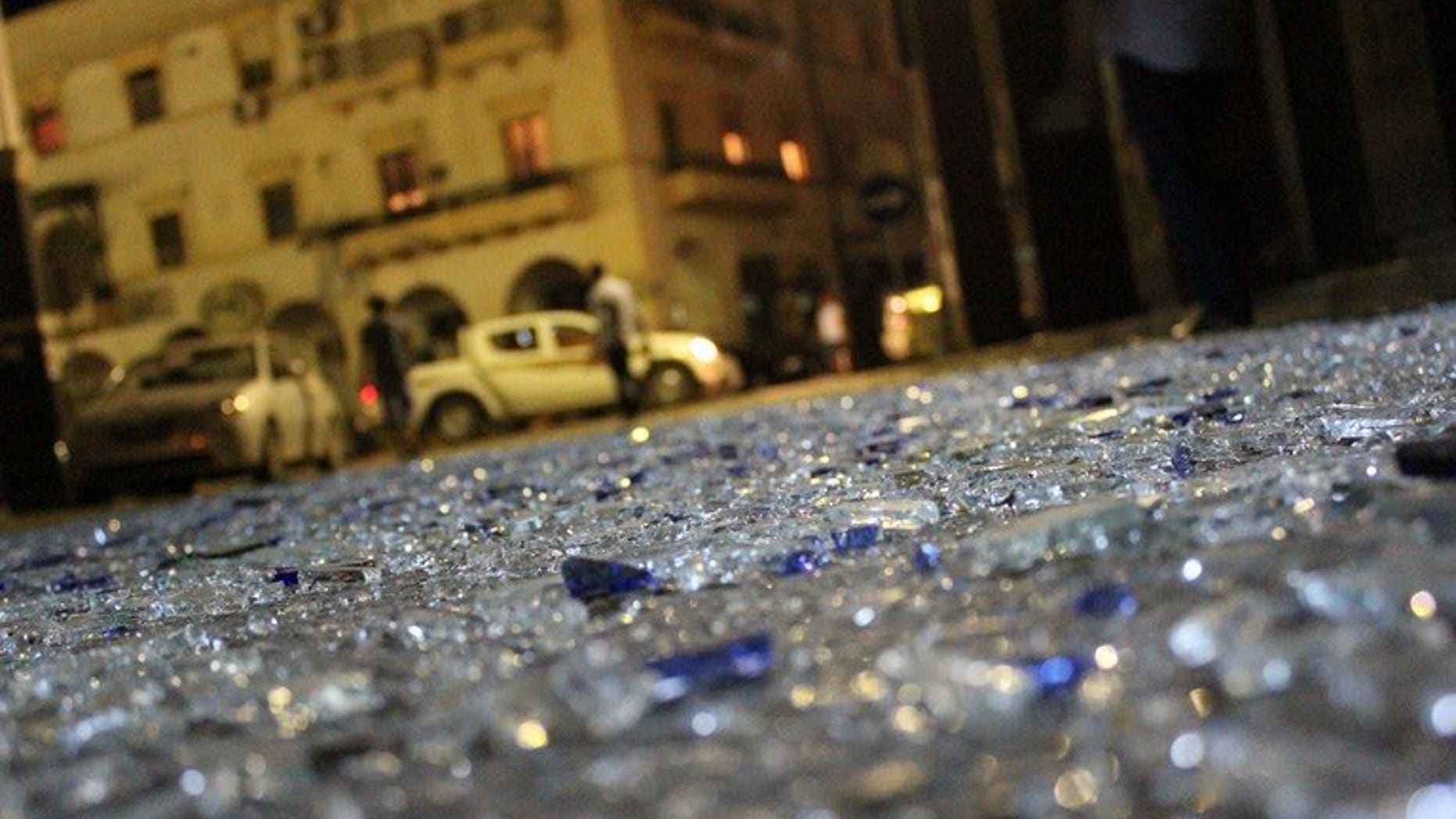 Pieces of glass litter the street in Benghazi on July 28, 2013 after two powerful explosions. A bomb exploded Saturday in front of Egypt's consulate in the eastern Libyan city of Benghazi, causing some damage to the building but no casualties, a security official said.