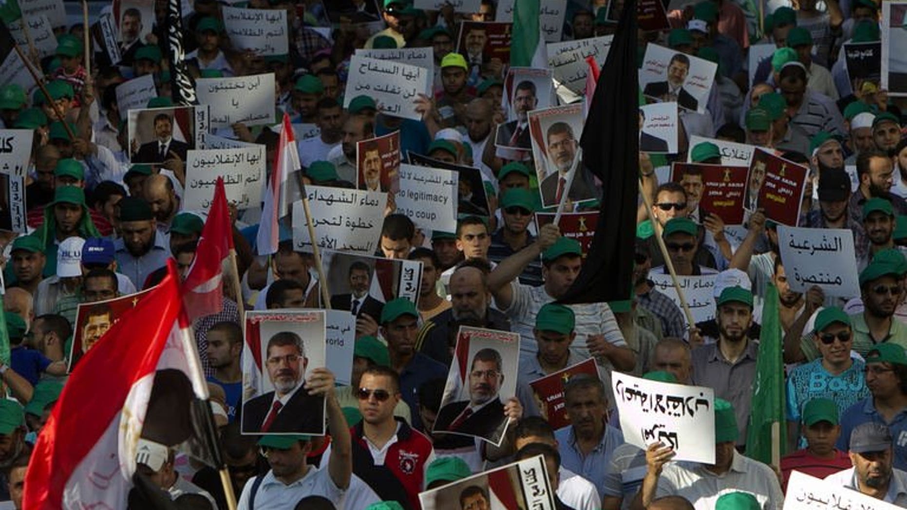 Members of the Arab-Israeli Islamic Movement protest in support of deposed Egyptian president Mohamed Morsi (portrait) and against the army crackdown on Muslim Brotherhood supporters, in the northern Israeli city of Nazareth on August 17, 2013.