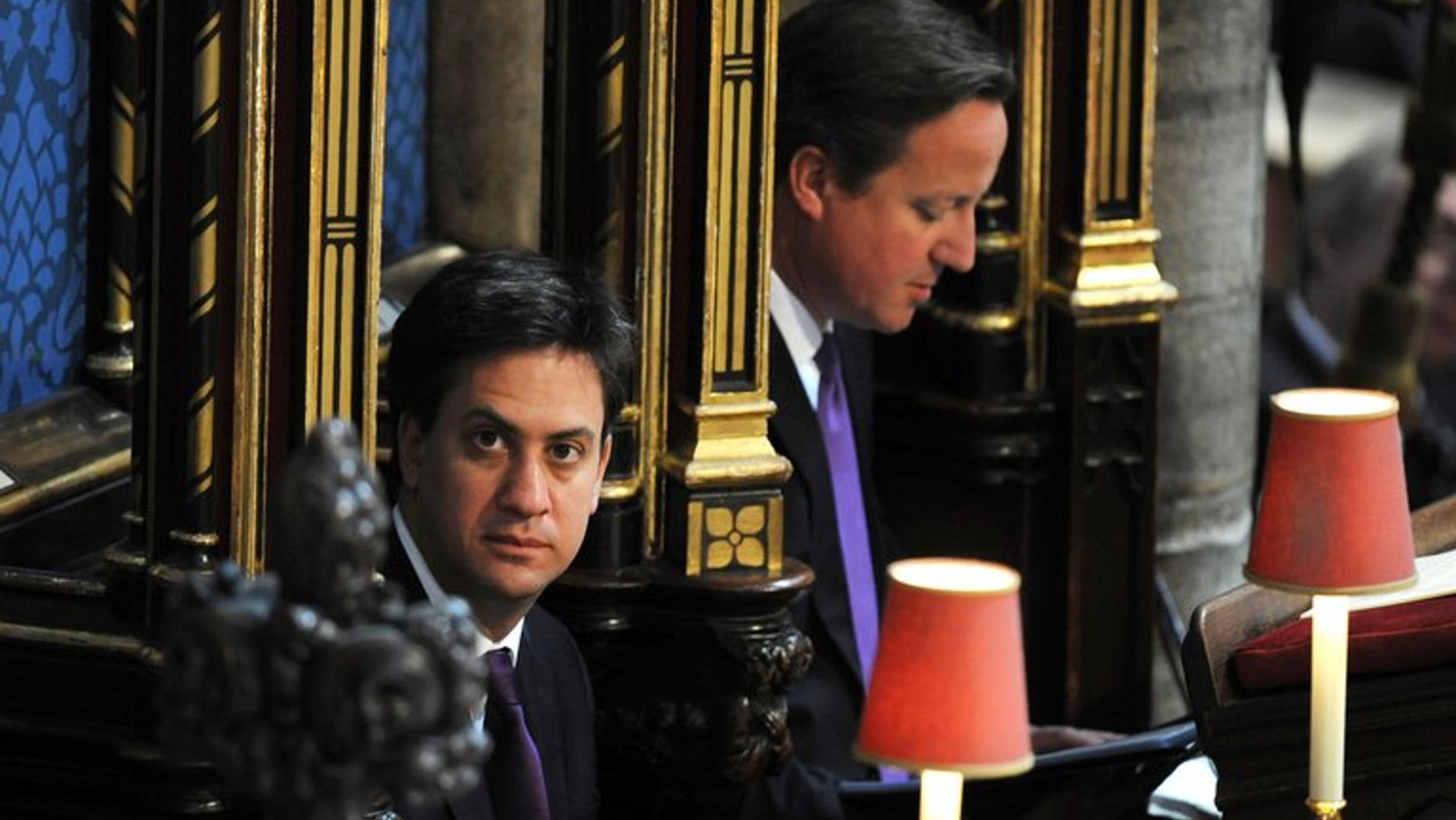 Prime Minister David Cameron (R) and Labour Party leader Ed Miliband attend a service at Westminster Abbey in London on June 4, 2013. Miliband has suffered a summer ratings slump, a poll out Sunday showed.