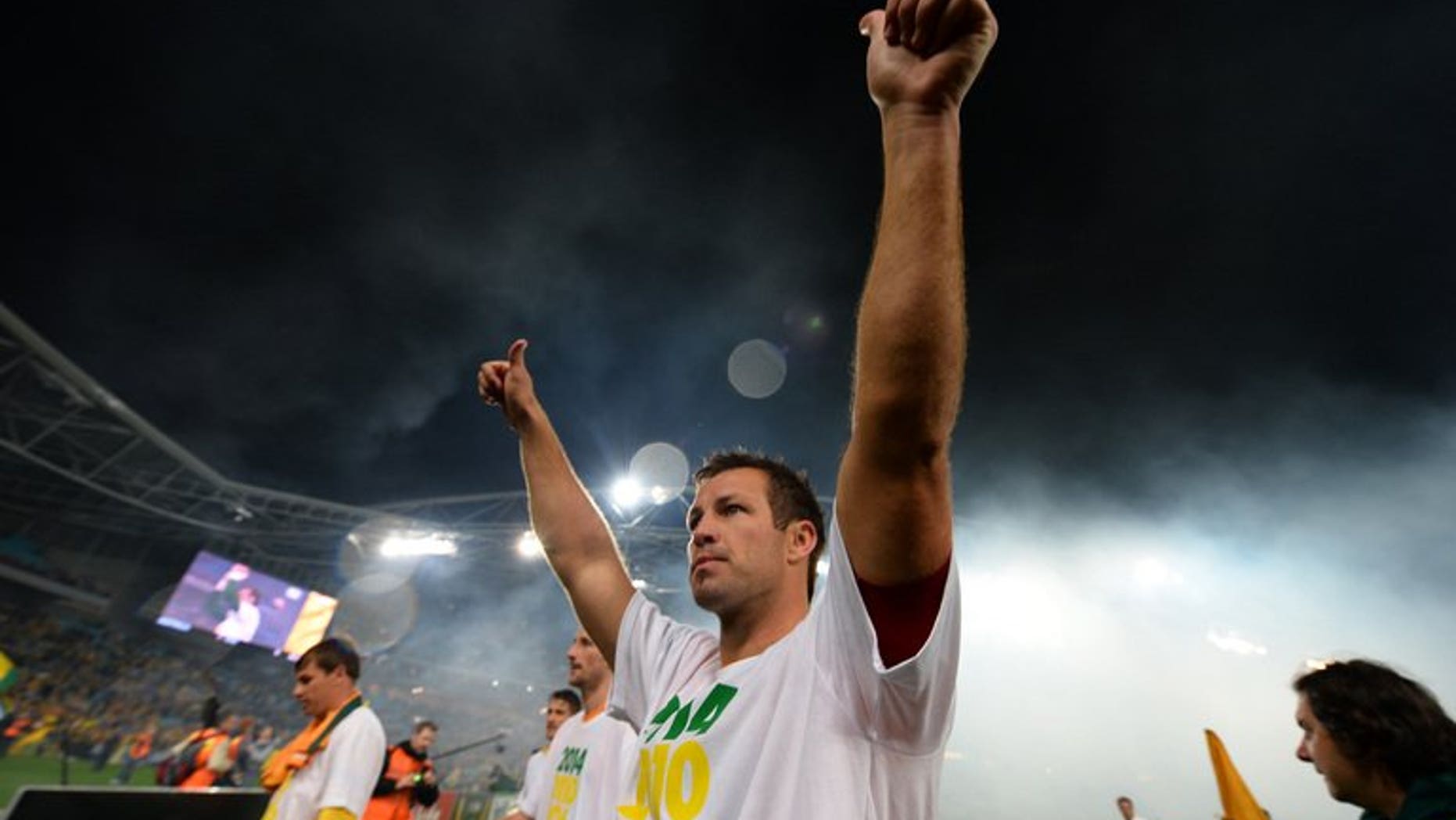 Australia's captain Lucas Neill acknowledges the crowd after his team's win against Iraq during their 2014 World Cup qualifier in Sydney on June 18, 2013. Neill has signed a contract with Japan's Omiya Ardija and is ready to play as early as next weekend, the J-League club announced Sunday.