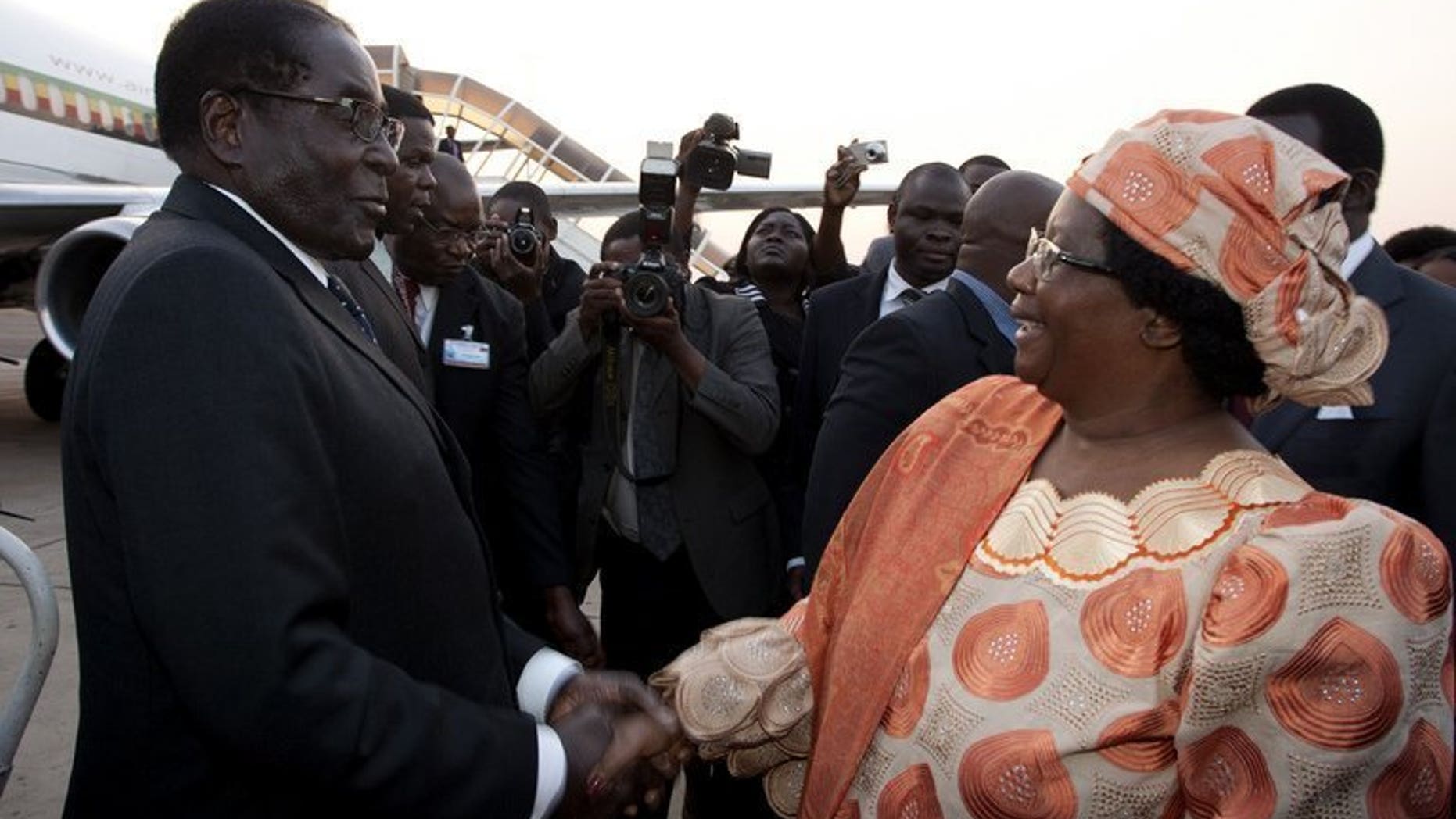 Malawi President Joyce Banda welcomes Robert Mugabe at Kamuzu Airport in Lilongwe on Friday. Mugabe will be sworn in on Thursday, beginning a fresh five-year mandate as Zimbabwe's president following a disputed election, his spokesman said Sunday