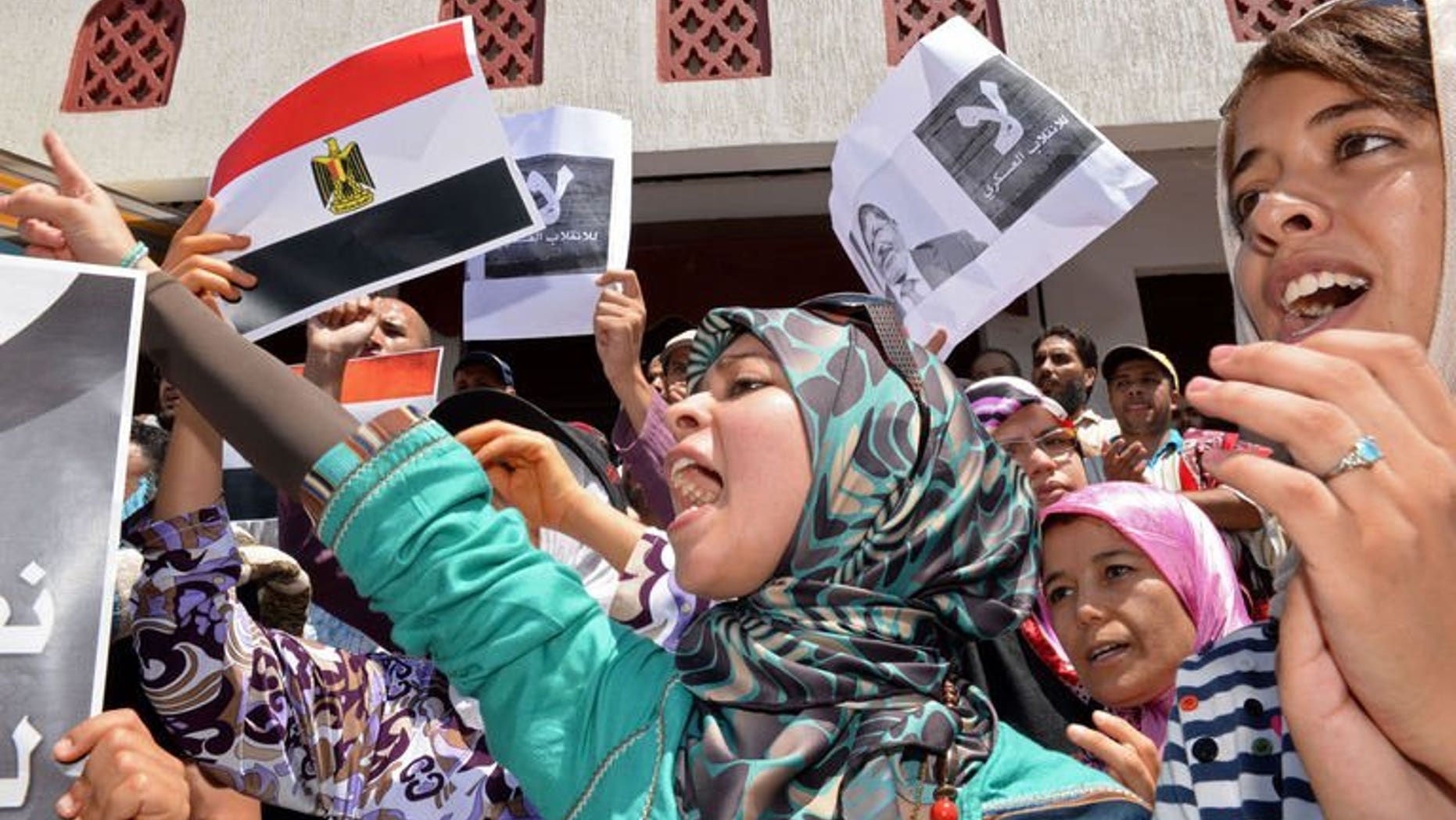 Moroccan protestors hold Egyptian flags during a rally in Rabat against the violence in Egypt on August 16, 2013. Around 10,000 people took part in a demonstration in the Moroccan capital on Sunday in support of Islamists in Egypt locked in a deadly showdown with security forces.