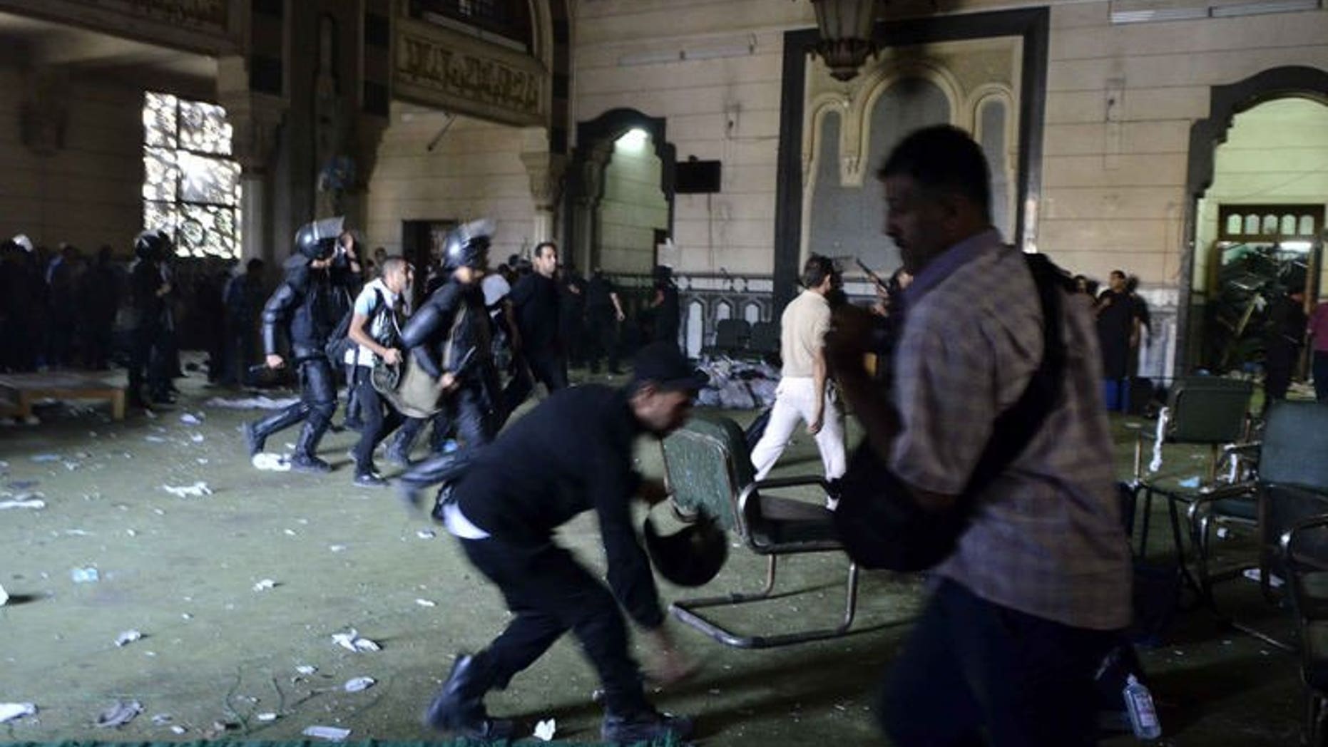 Egyptian riot policemen in Cairo's Al-Fath mosque where Islamist supporters of ousted Morsi holed up on August 17, 2013. Egyptian policemen fired tear gas at Islamist inmates who rioted and tried to escape during their transfer to a prison on Cairo's outskirts on Sunday, officials said.
