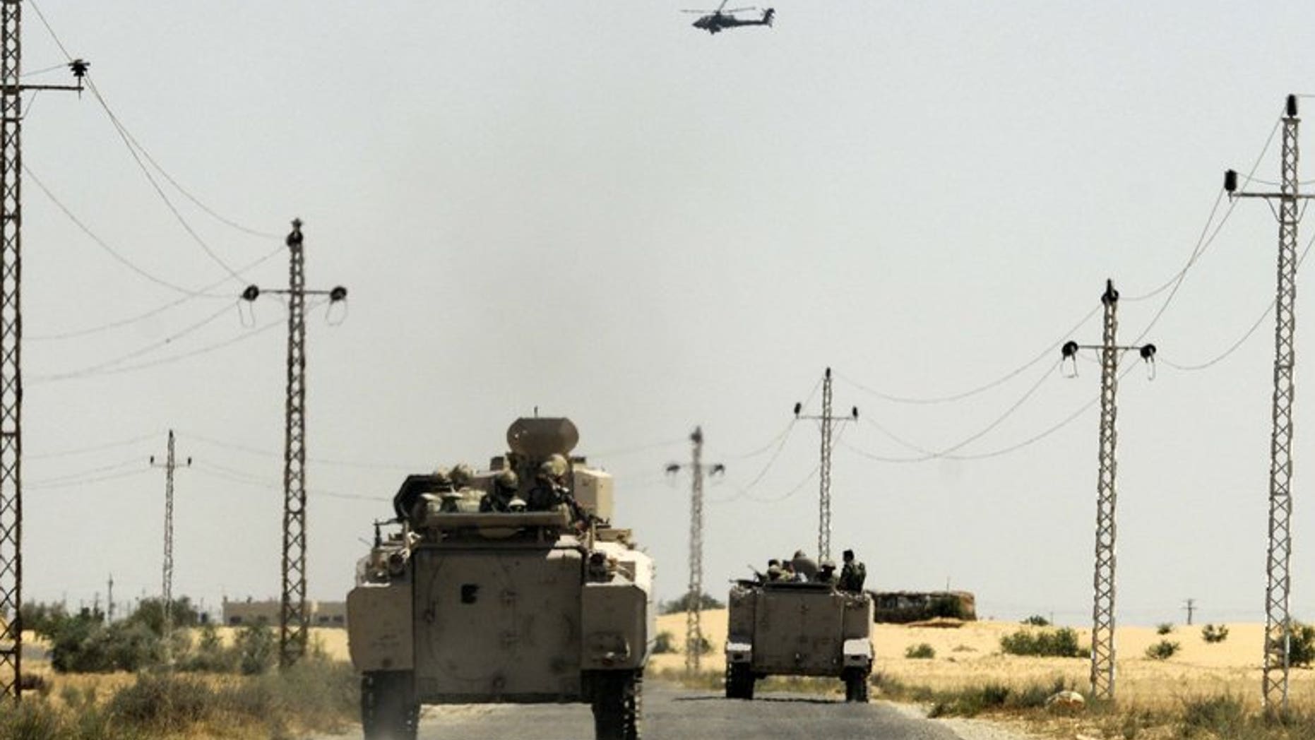 Egyptian soldiers and a military helicopter are seen in the area near the Rafah border crossing, on May 21, 2013. Militants fired rocket-propelled grenades at two buses packed with Egyptian policemen in Sinai, killing 24 in the deadliest attack of its kind in years.
