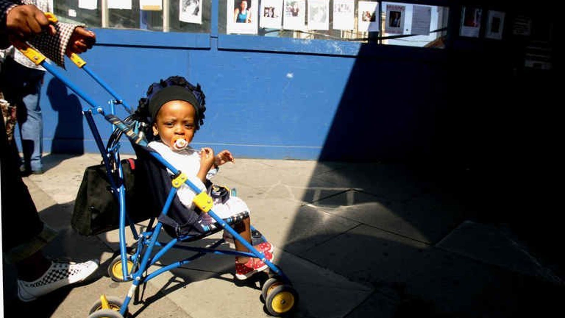 A baby in a pram looks around at Kings Cross station in London on July 12, 2005. Family budgets are being squeezed as the cost of bringing up a child rises to ??148,000, a charity said.
