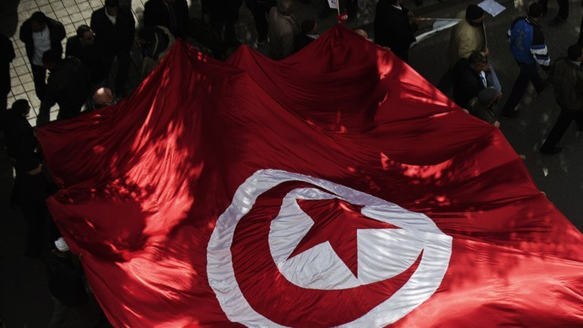 Tunisian supporters of ruling Islamist party Ennahda march through Tunis's Habib Bourguiba Avenue during a demonstration on February 16, 2013. Tunisia was to push ahead with talks to resolve a political crisis sparked by the assassination of an opposition politician last month, but with no signs of compromise.