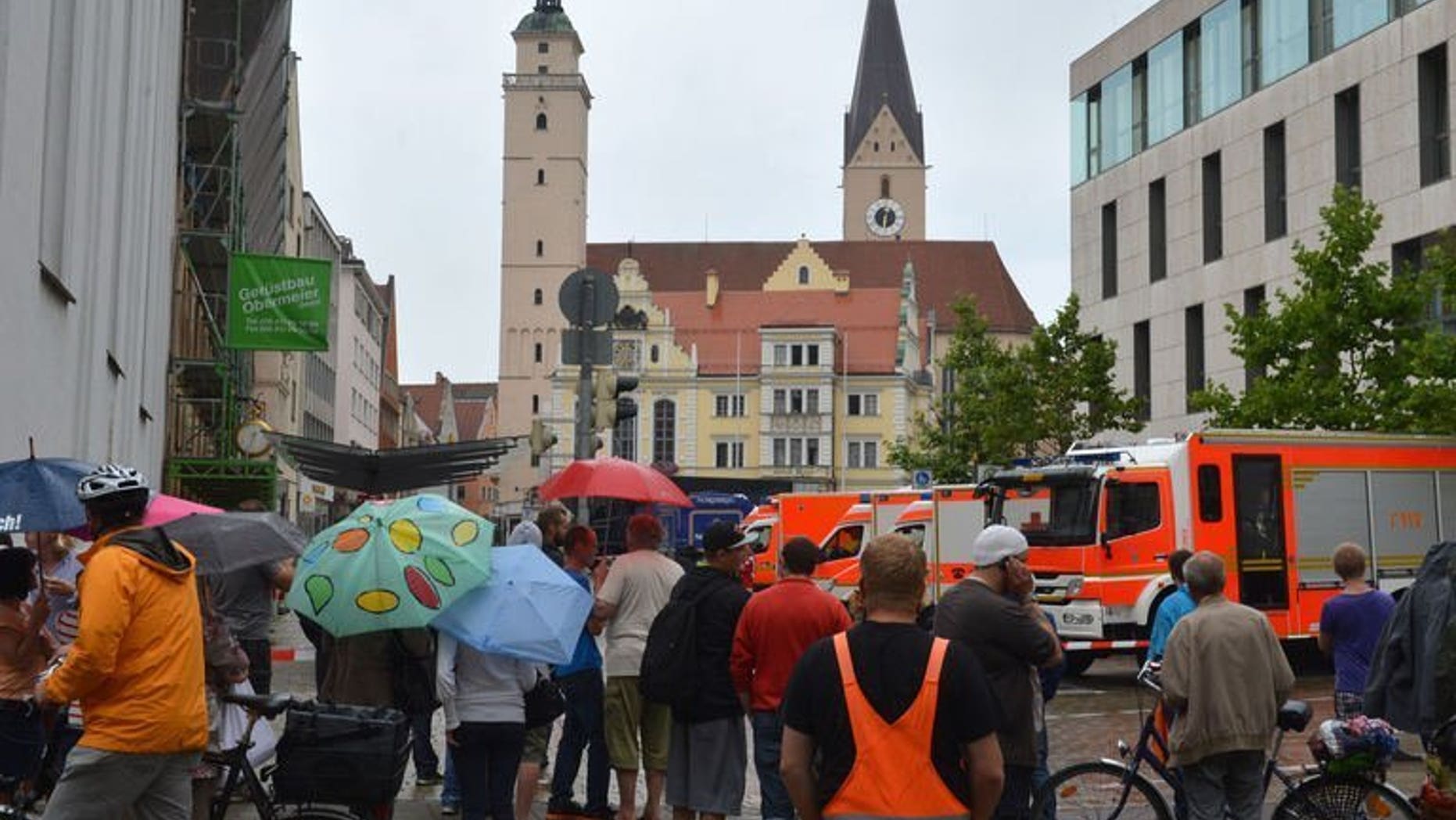 Onlookers stand in a street near the town hall in Ingolstadt, southern Germany, on August 19, 2013. A man claiming to be armed took several hostages in the town hall on Monday, police said.