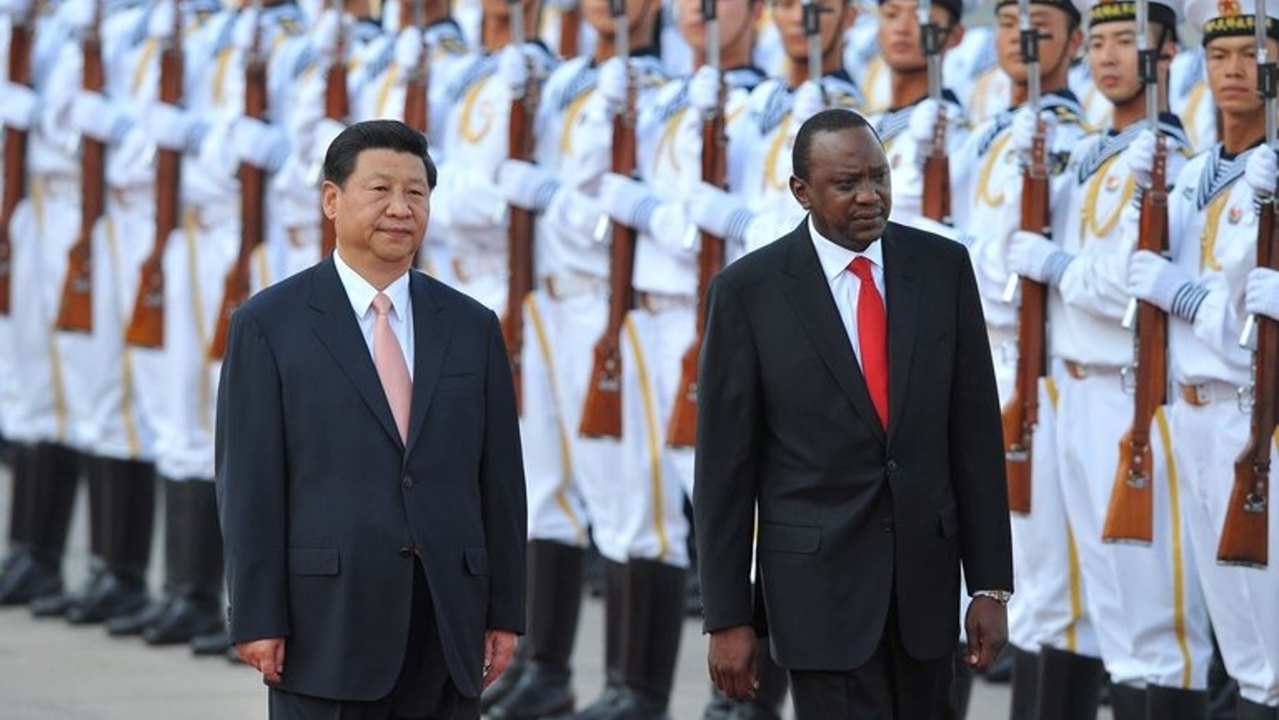 Kenya's President Uhuru Kenyatta (right) and Chinese President Xi Jinping inspect Chinese honour guards during a welcoming ceremony in Beijing on August 19, 2013. Kenyatta, who faces trial on charges of crimes against humanity, was welcomed to China with a 21-gun salute and a meeting with Xi.