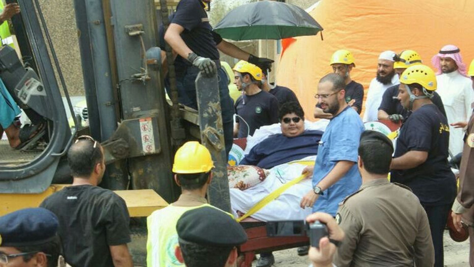 Saudi Khaled Mohsin Shairi, who suffers from extreme obesity weighing 610 kilograms, is transported with a fork-lift truck on August 19, 2013 at the airport in Riyadh.