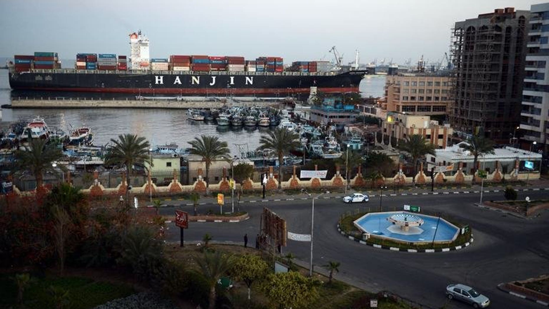 This file photo shows a container ship passing through the Suez Canal city of Port Said, on March 9, 2013. Gas-rich Qatar has dispatched a second shipment of free liquefied gas it had pledged to Egypt, a report said, despite Doha's criticism of Cairo's deadly crackdown on Muslim Brotherhood protesters.