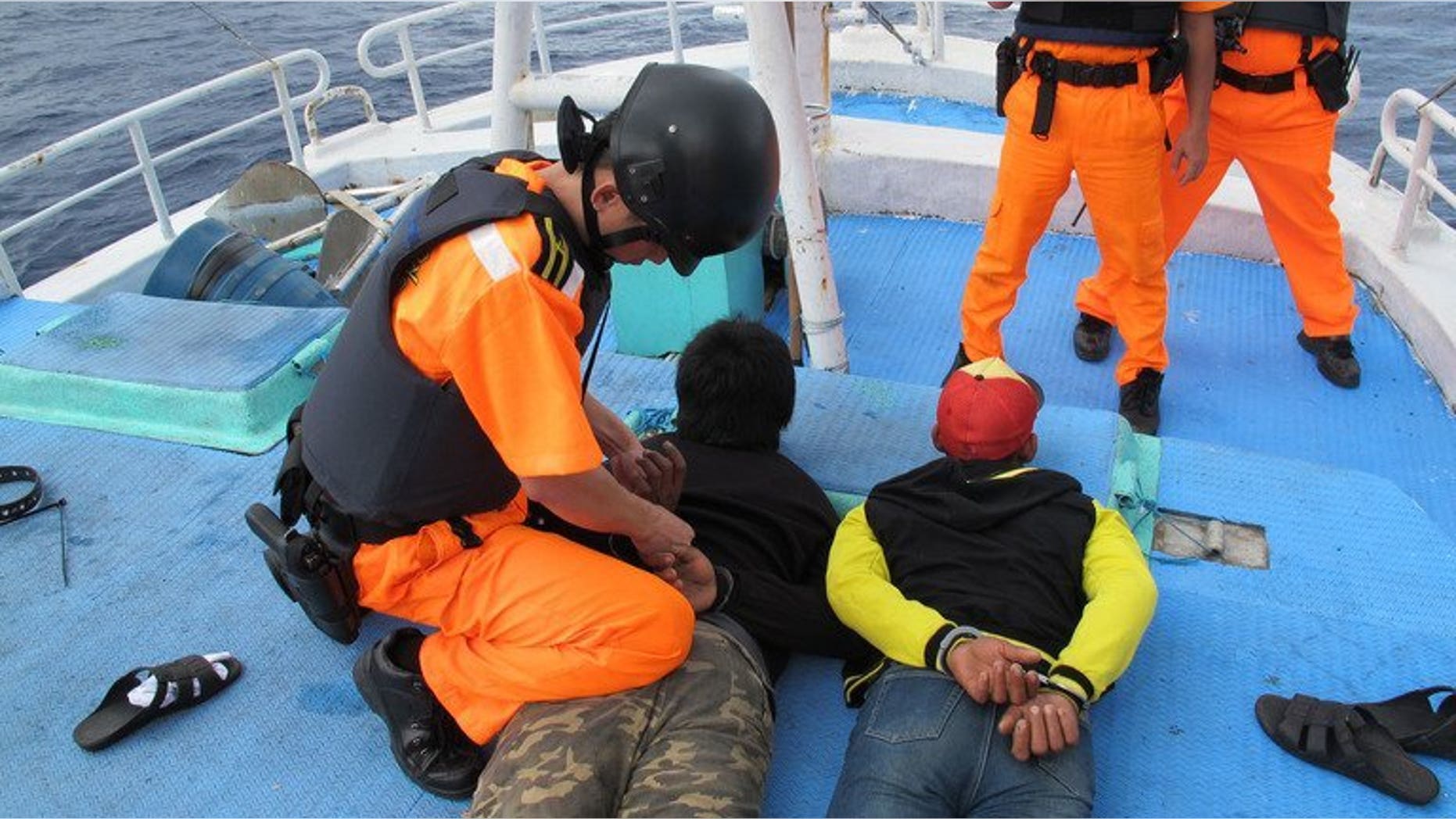 Undated photo released by Taiwan's Coast Guard Administration on August 20, 2013 shows Indonesian fishermen under arrest in the northeastern fishing port of Suao in Ilan. Nine Indonesian fishing boat crewmen suspected of murdering their Taiwanese captain and chief engineer faced an angry attack from relatives when they were brought back to the island on Tuesday to stand trial.
