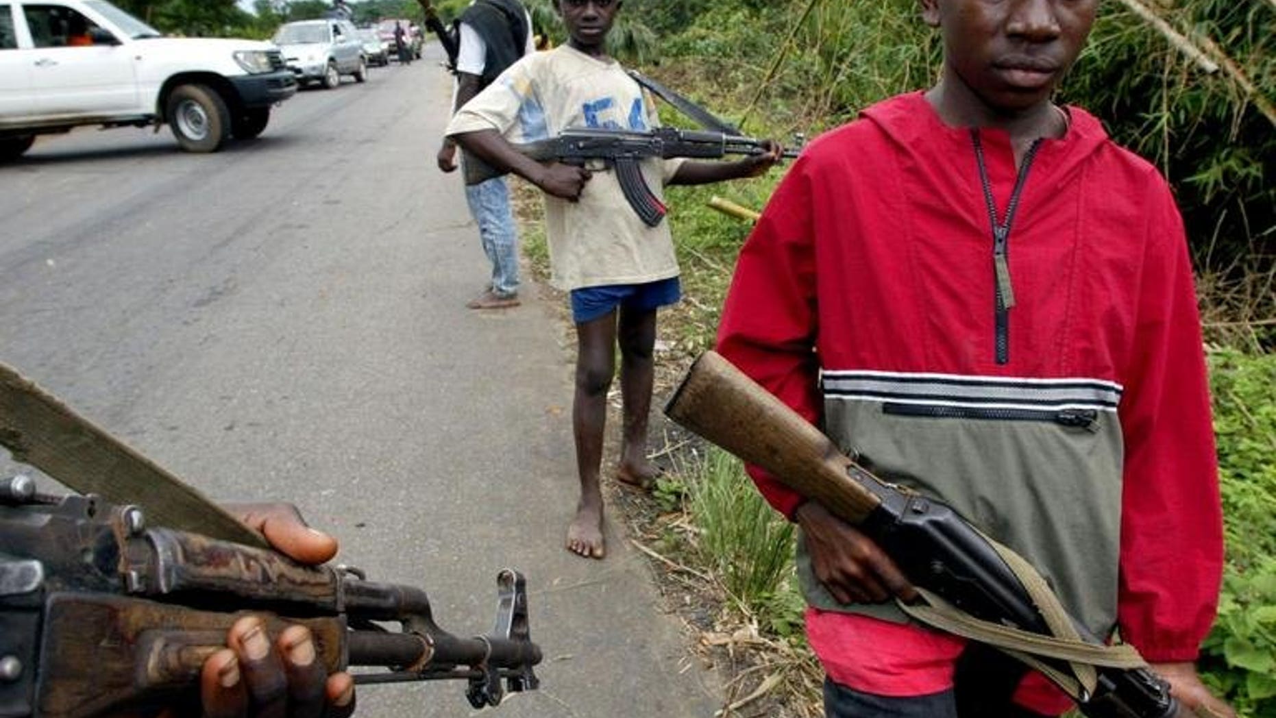 Young LURD rebels stand guard on August 19, 2003 at the southern entry to the river Po bridge 30 kilometres from Monrovia. The former leader of one of Liberia's main rebel groups which fought a bloody civil war that claimed thousands of lives said Tuesday he had been backed by neighbouring Guinea.