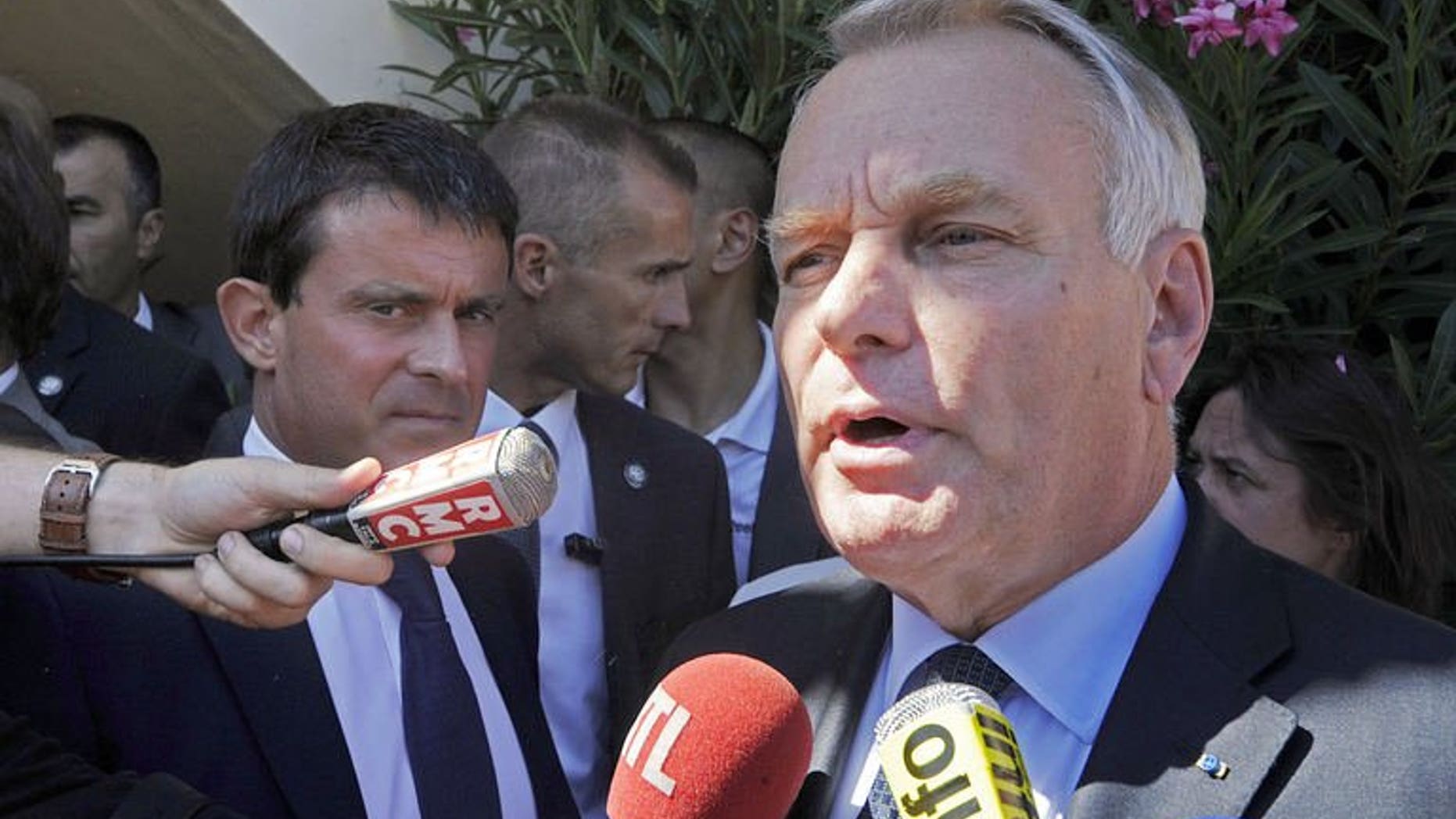 French Prime Minister Jean-Marc Ayrault (R) speaks to journalists, on August 20, 2013, in Marseille, as French Interior Minister Manuel Valls looks on. French authorities vowed action to fight rampant street crime in the southern port of Marseille on Tuesday after the latest in a string of deadly gang shootings in France's second-largest city.