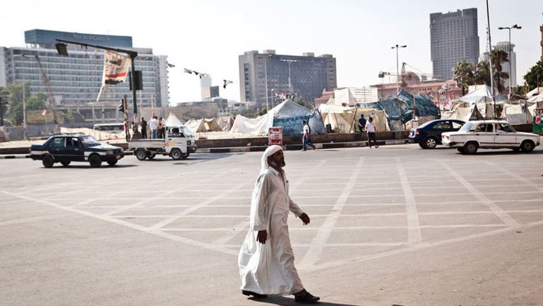 An Egyptian man walks in Tahrir Square, after it has been partially reopened to traffic, on August 20, 2013 in Cairo. European Union foreign policy chief Catherine Ashton said Tuesday that she had offered to return to Cairo to help facilitate a way out of the country's crisis.