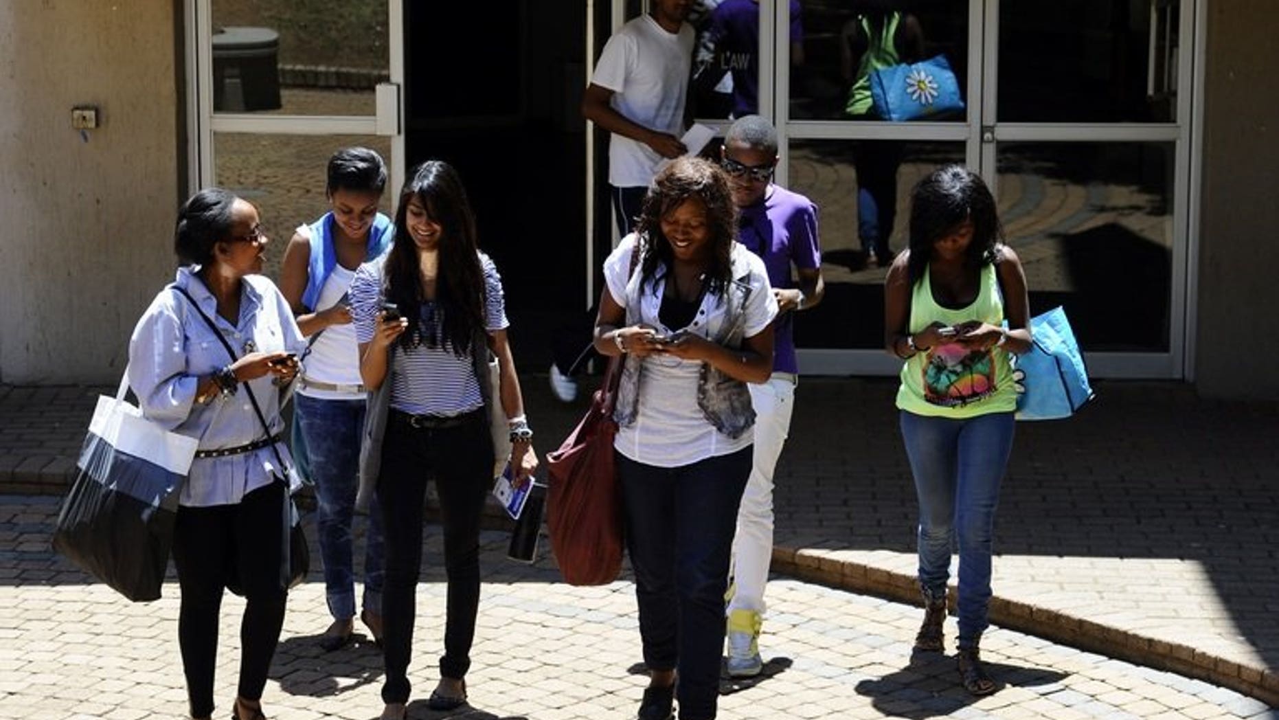 Students use their mobile phones after class on October 20, 2010 at the Witwatersrand University in Johannesburg. The university launched a campaign to attract Africa's top postgraduate talent Tuesday, intensifying the continent's battle for brains.