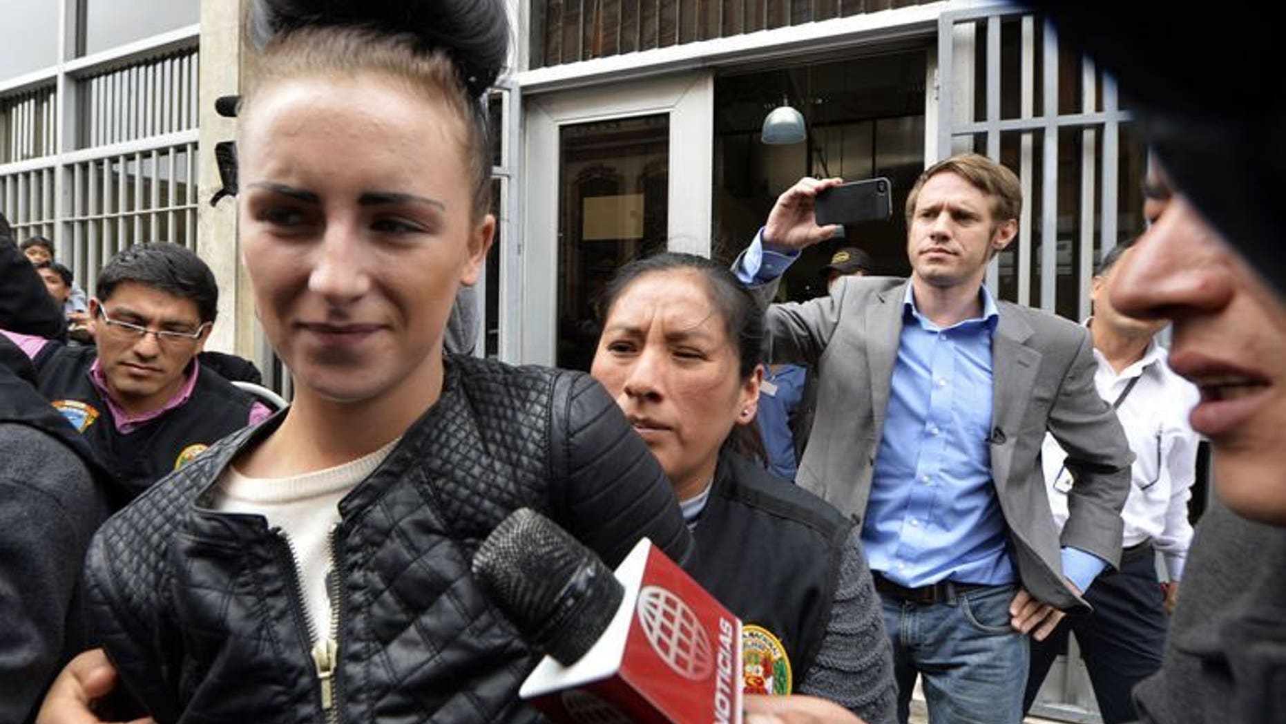 Irish citizen Michaella McCollum Connolly, 20, is escorted out of the Callao prosecutor's building on August 20, 2013, to be taken to the district court with her British companion Melisa Reid. The pair were arrested at Lima airport as they tried to board a flight to Spain carrying what Peruvian police said was 11 kilos of cocaine.