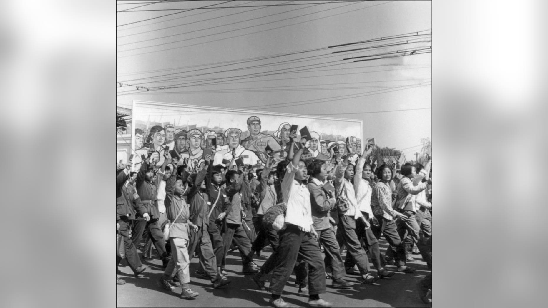 Red Guards, high school and university students, wave copies of Chairman Mao Zedong's "Little Red Book," while on parade in June 1966 in Beijing. The son of a legendary Communist military leader and politician in China has publicly apologised for persecuting people at his school during the Cultural Revolution, according to a blog.