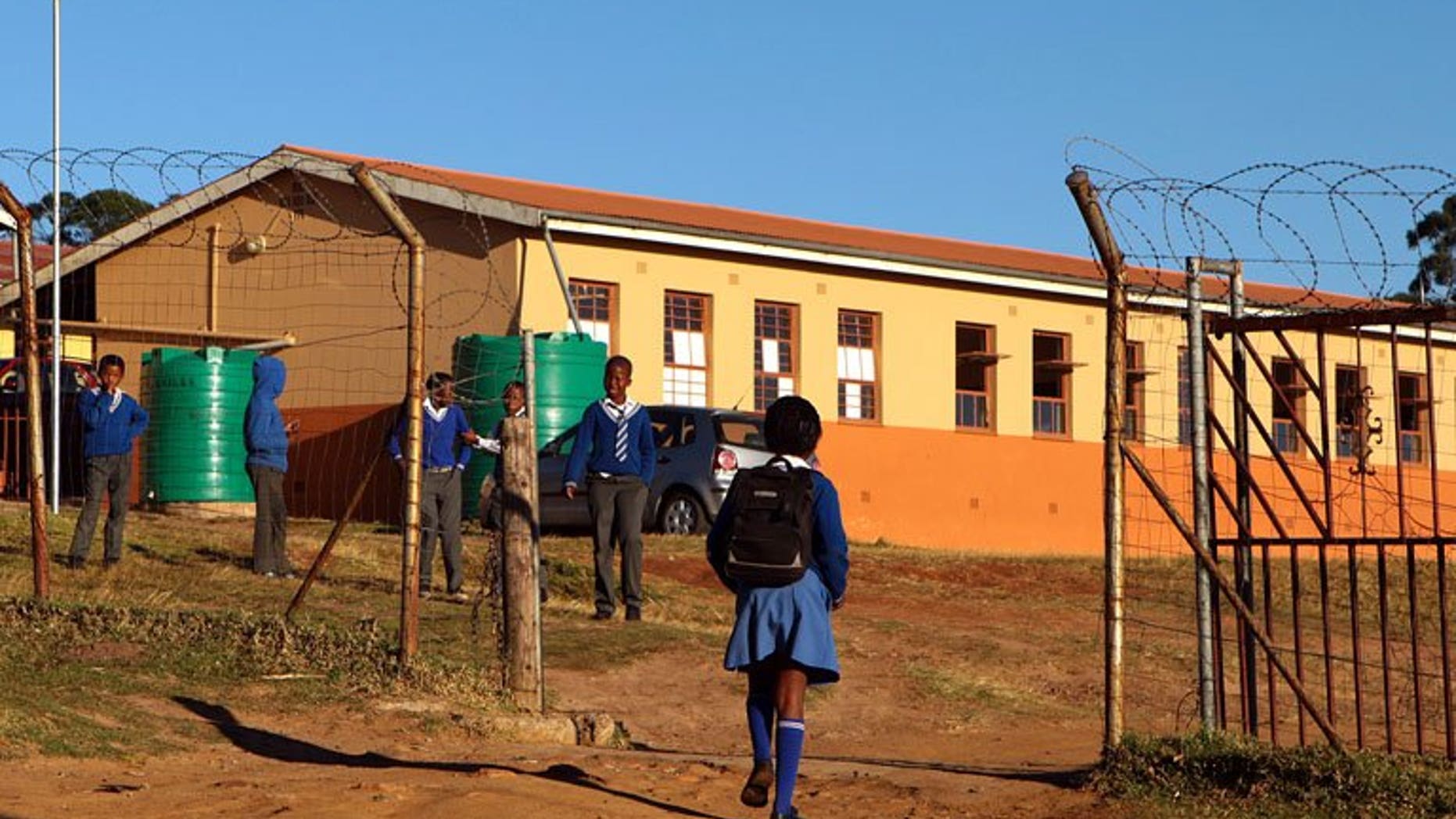 Children arrive at a South African village school on June 14. South African police conducting a nationwide sweep arrested six men suspected of producing and distributing child pornography as part of a global crime ring, a spokesman said Wednesday.
