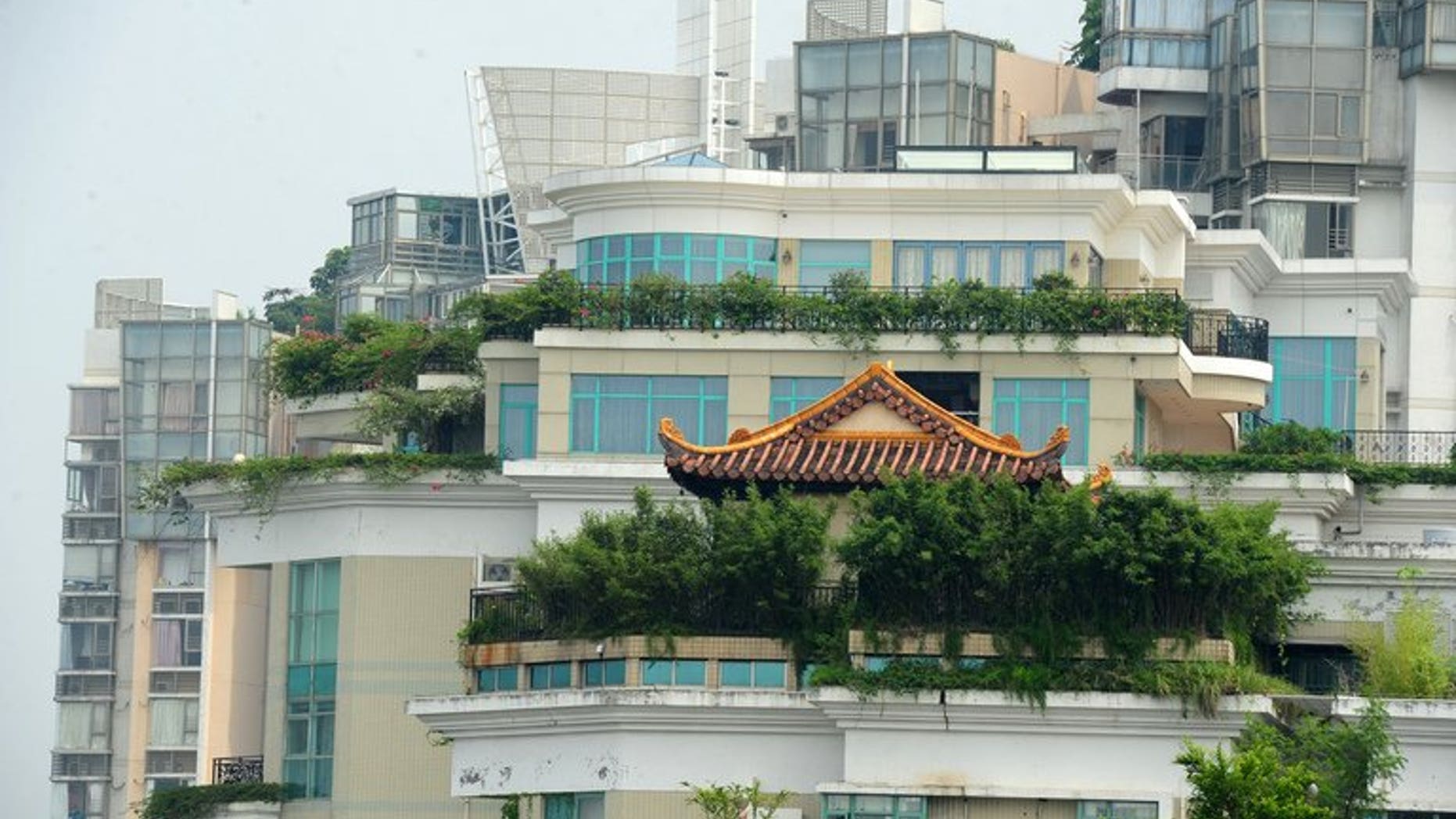 A temple is seen on the rooftop of a 21-storey apartment building in Shenzhen, south China's Guangdong province on August 21, 2013. The latest rooftop architectural wonder highlighted in China is a temple that brings worshippers closer to the heavens by being on top of a 21-storey apartment block.