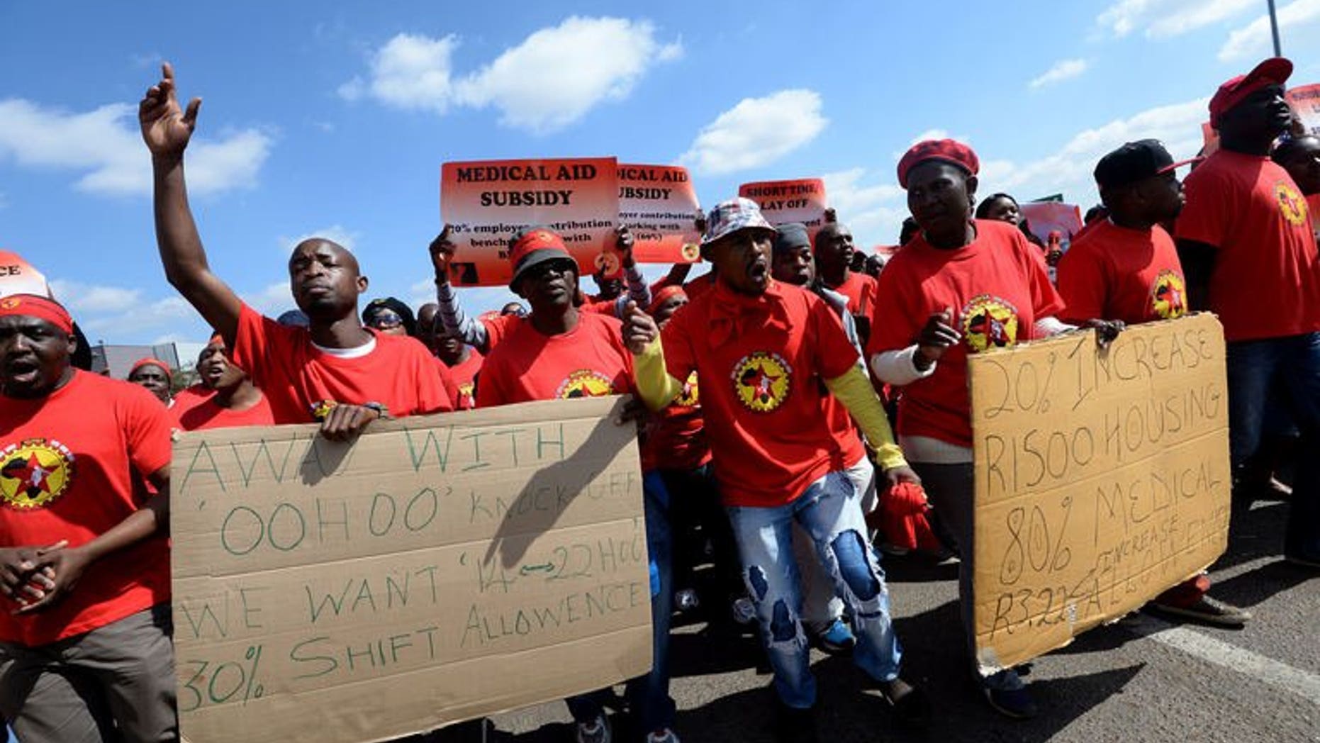 Workers on strike hold signs as they take part in a demonstration outside Ford's plant in Pretoria on August 20, 2013. South African 12-month consumer price inflation jumped to 6.3 percent in July from 5.5 percent in June due to higher fuel prices, official figures showed on Wednesday.
