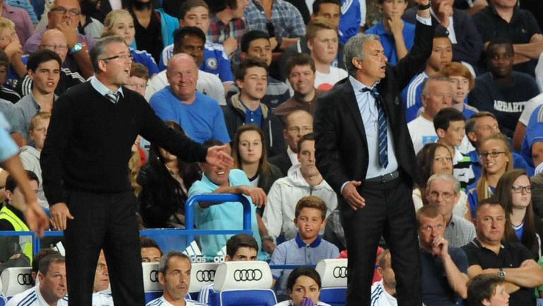 Aston Villa's Scottish manager Paul Lambert (L) and Chelsea's Portuguese manager Jose Mourinho (R) react during the English Premier League football match between Chelsea and Aston Villa at Stamford Bridge in London on August 21, 2013.