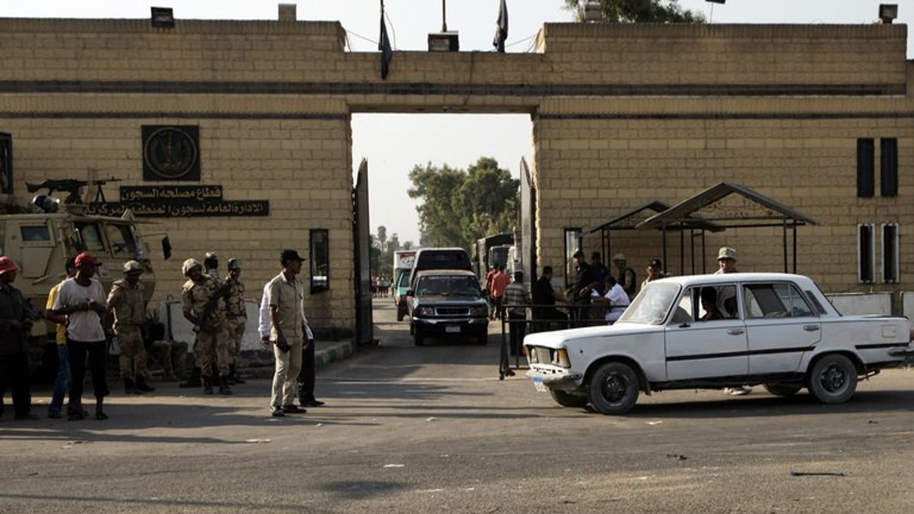 Egyptian security forces stand guard outside one of the gate of the Tora prison where former Egyptian president Hosni Mubarak is detained on August 21, 2013 in Cairo. Egyptians awaited Thursday the possible release of Mubarak after a court ordered he be freed pending his re-trial on charges of complicity in the deaths of protesters, and other crimes.