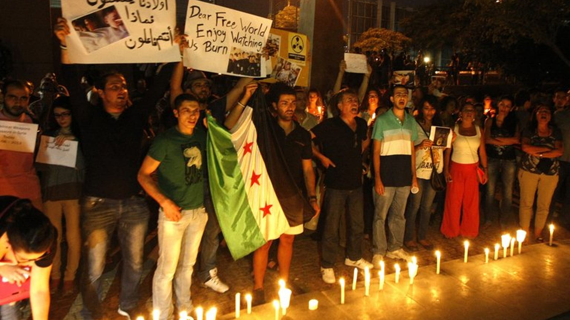 Lebanese and Syrian civilians hold a candlelit vigil in front of the UN headquarters in Beirut, in solidarity with Syrian civilians killed in attacks in the suburbs of Damascus on August 21, 2013. Syrian forces blasted rebel zones near Damascus on Thursday, including areas where the opposition alleged loyalists had launched a chemical weapons attack a day earlier, a monitoring group said.