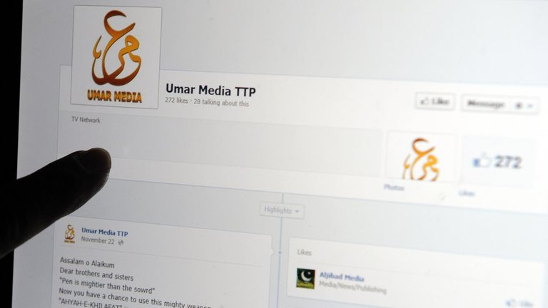 A Pakistani journalist gestures at a Facebook page used by Tehreek-e-Taliban Pakistan (TTP) on a laptop computer screen in Islamabad on December 7, 2012. A Pakistani militant group Thursday welcomed a call for dialogue by Prime Minister Nawaz Sharif with extremists to end bloodshed that has left thousands dead.