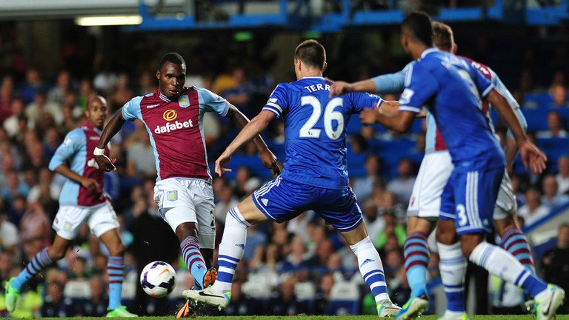 John Terry (centre) tackles Aston Villa's Christian Benteke at Stamford Bridge on Wednesday. Aston Villa manager Paul Lambert on Thursday claimed that his side were the victims of double standards after being denied a late penalty in their Premier League defeat at Chelsea.