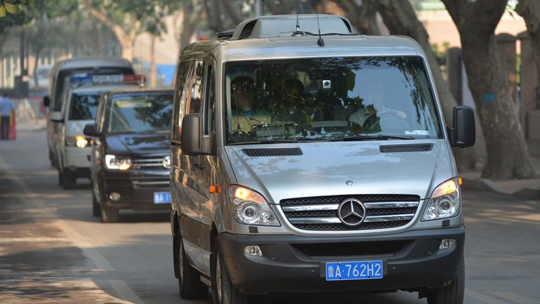 The convoy believed to be carrying disgraced politician Bo Xilai arrives at the Intermediate People's Court in Jinan, Shandong Province on August 23, 2013, for day two of his bribery trial.