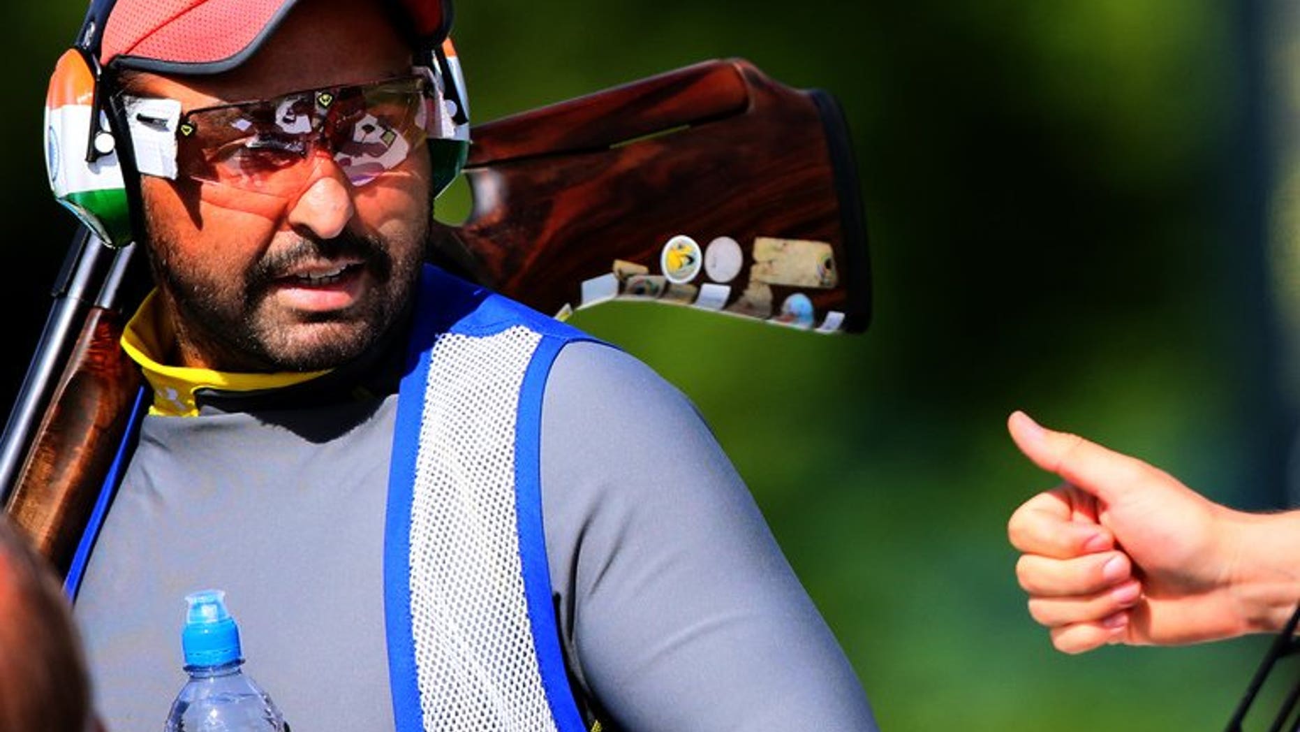 Ronjan Sodhi receives a thumbs-up from a fellow competitor during the men's Double Trap qualification of the shooting event of the London Olympic Games, at the Royal Artillery Barracks, on August 2, 2012. Sodhi, a double-trap world record holder in 2010 and 2011, has been named winner of India's highest sports award.