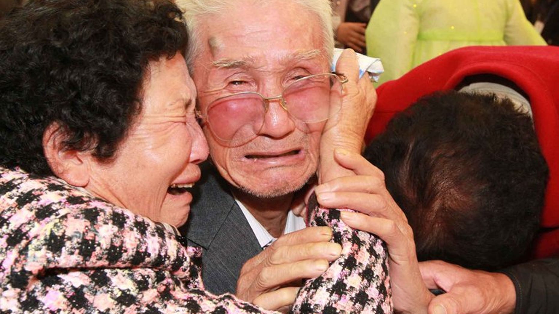 North Korean Kim Jin-Won (centre) cries with his South Korean relatives as they bid farewell following their three-day separated family reunion meeting at Mount Kumgang resort on the North's southeastern coast, near the border, on November 1, 2010. South and North Korea agreed Friday to go ahead with reunions next month for families separated for decades by the 1950-53 Korean War, Seoul said.