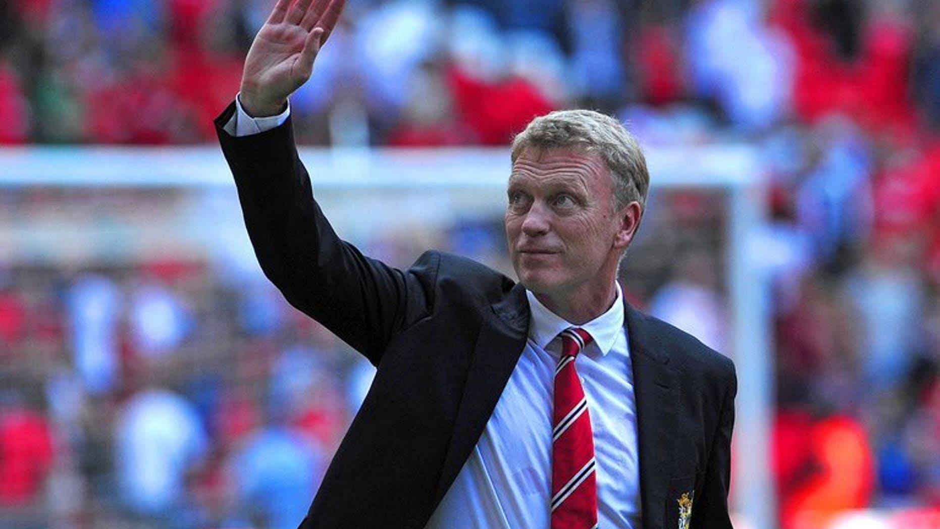 Manchester United manager David Moyes waves as United celebrate after beating Wigan Athletic the FA Community Shield at Wembley Stadium in north London on August 11, 2013. Moyes admits he will put faith in the club's youngsters if the Premier League champions are unable to land their major transfer targets