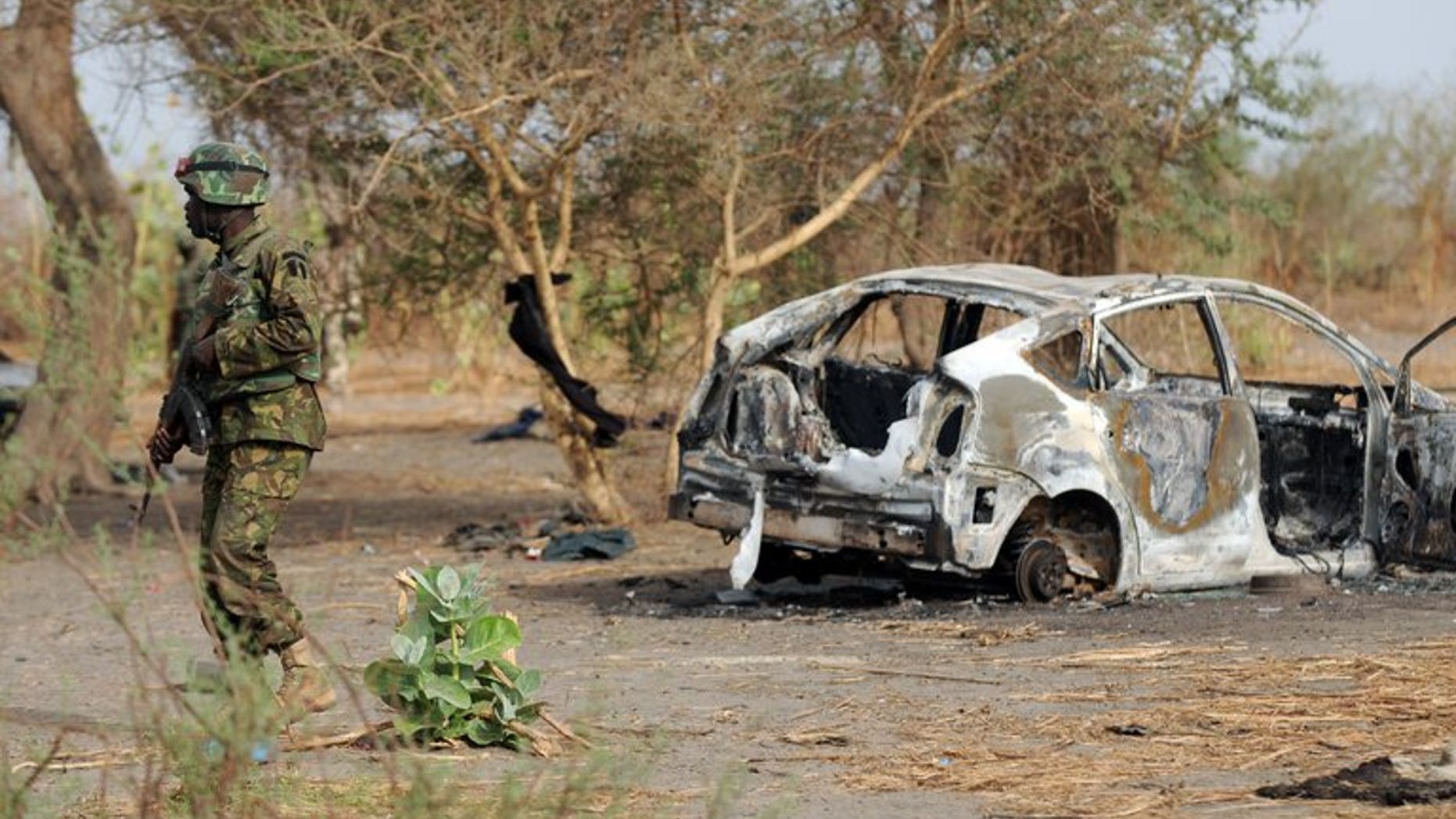 Nigerian soldiers patrol close to a former Boko Haram camp on June 5, 2013 near Maiduguri. Suspected members of Islamist extremist group Boko Haram have attacked a village in northeastern Nigeria, killing at least 35 people and wounding 14, the military said on Friday.