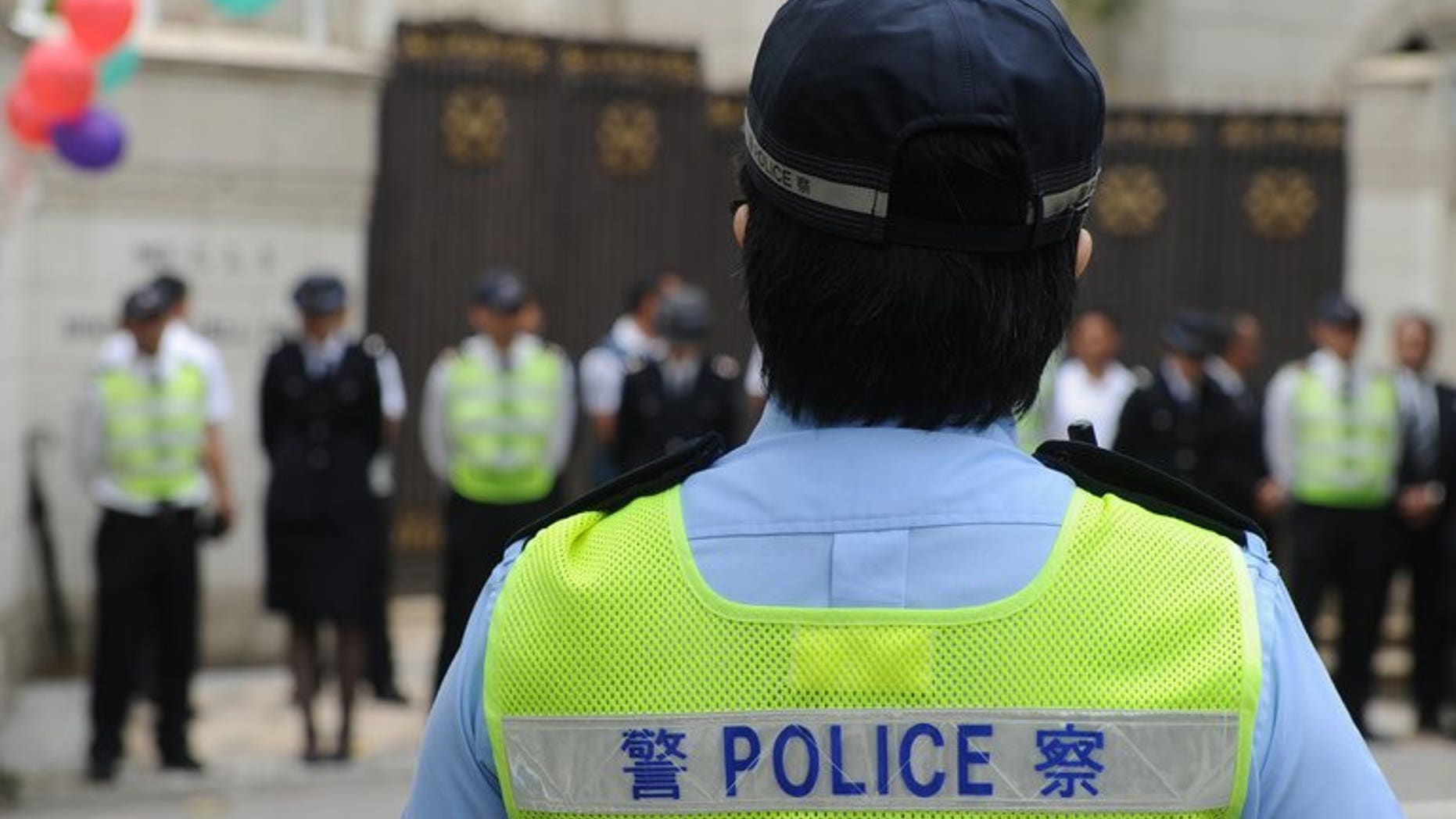 Police keep vigil in Hong Kong on April 21, 2013. Hong Kong police said Friday they had arrested more than 1,800 people during anti-triad raids for crimes including illegal gambling and drug offences.