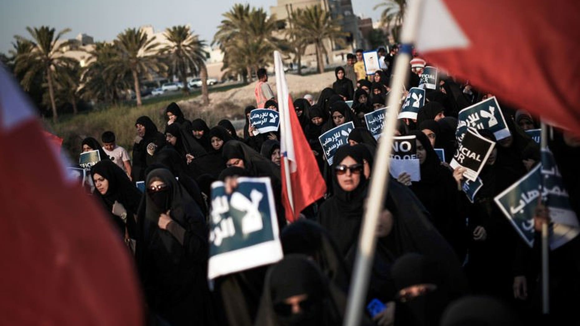 Bahraini women carry posters during an anti-government rally in the village of Abu Saiba, west of Manama, on August 23, 2013. Shiite protesters took to the streets in Bahrain Friday demanding political reforms in the Sunni-ruled Gulf kingdom, witnesses said.