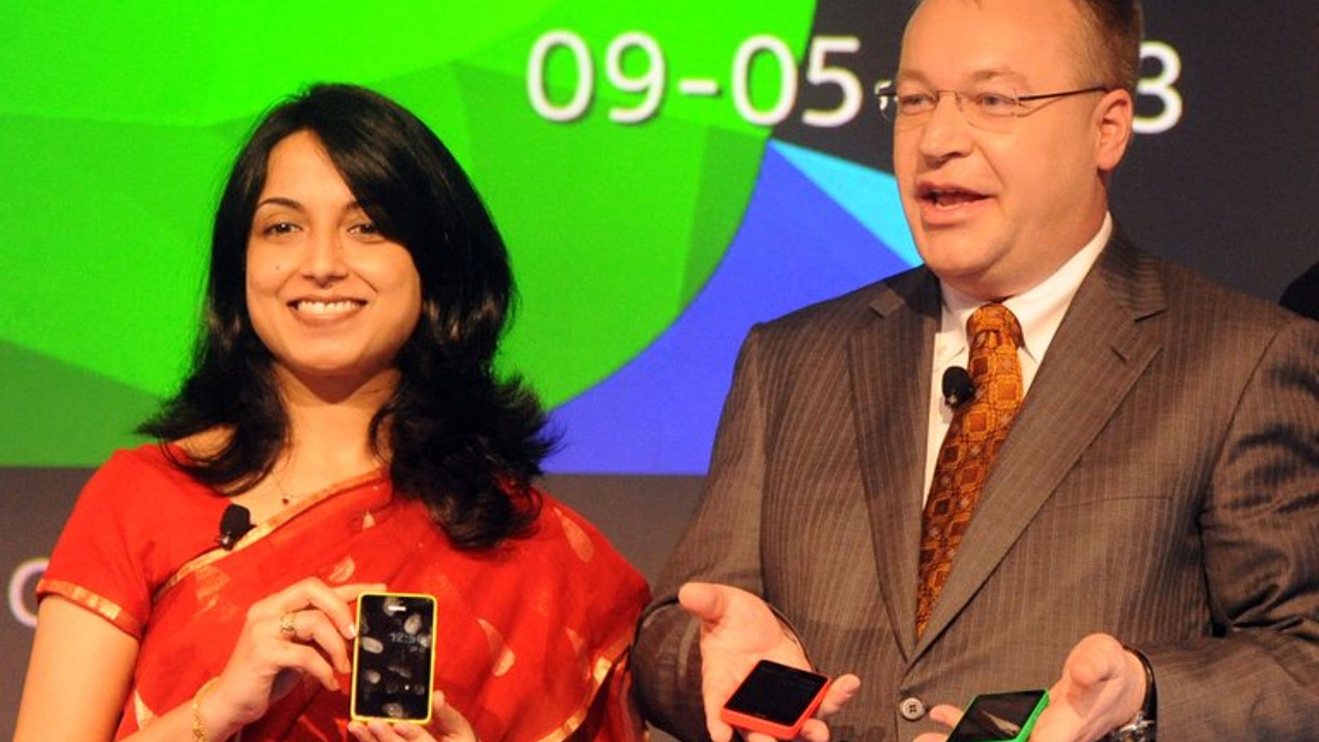 Nokia Corporation, CEO, Stephen Elop (right) and Head-Developer Outreach of Nokia, Sangeeta Bavi hold Nokia Asha 501 cellular telephones in New Delhi on May 9, 2013. The Finnish telecom giant said Saturday it is in talks with India's government about how to create a better business climate and remains "committed" to its manufacturing plant in the country.