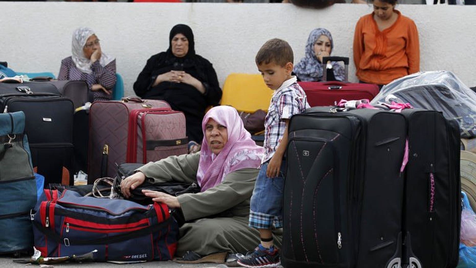 Palestinians wait at the Rafah border terminal in the southern Gaza Strip before crossing into neighbouring Egypt on August 24, 2013.