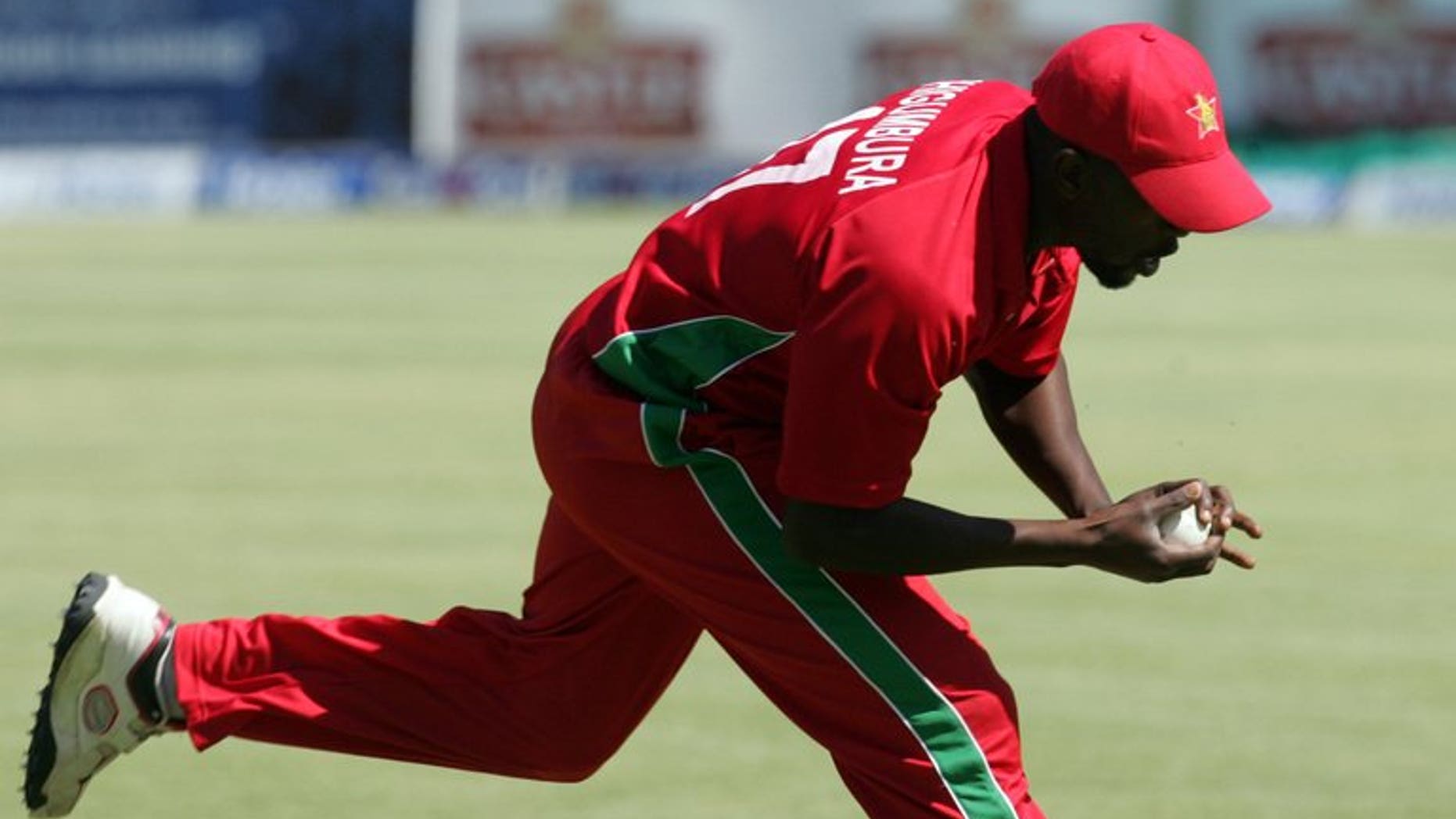 Zimbabwe's fielder Elton Chigumbura takes a catch in the deep during the second and final Twenty20 international between Zimbabwe and Pakistan at the Harare Sports Club on August 24, 2013. The home side looked to earn a share of the series on Saturday.
