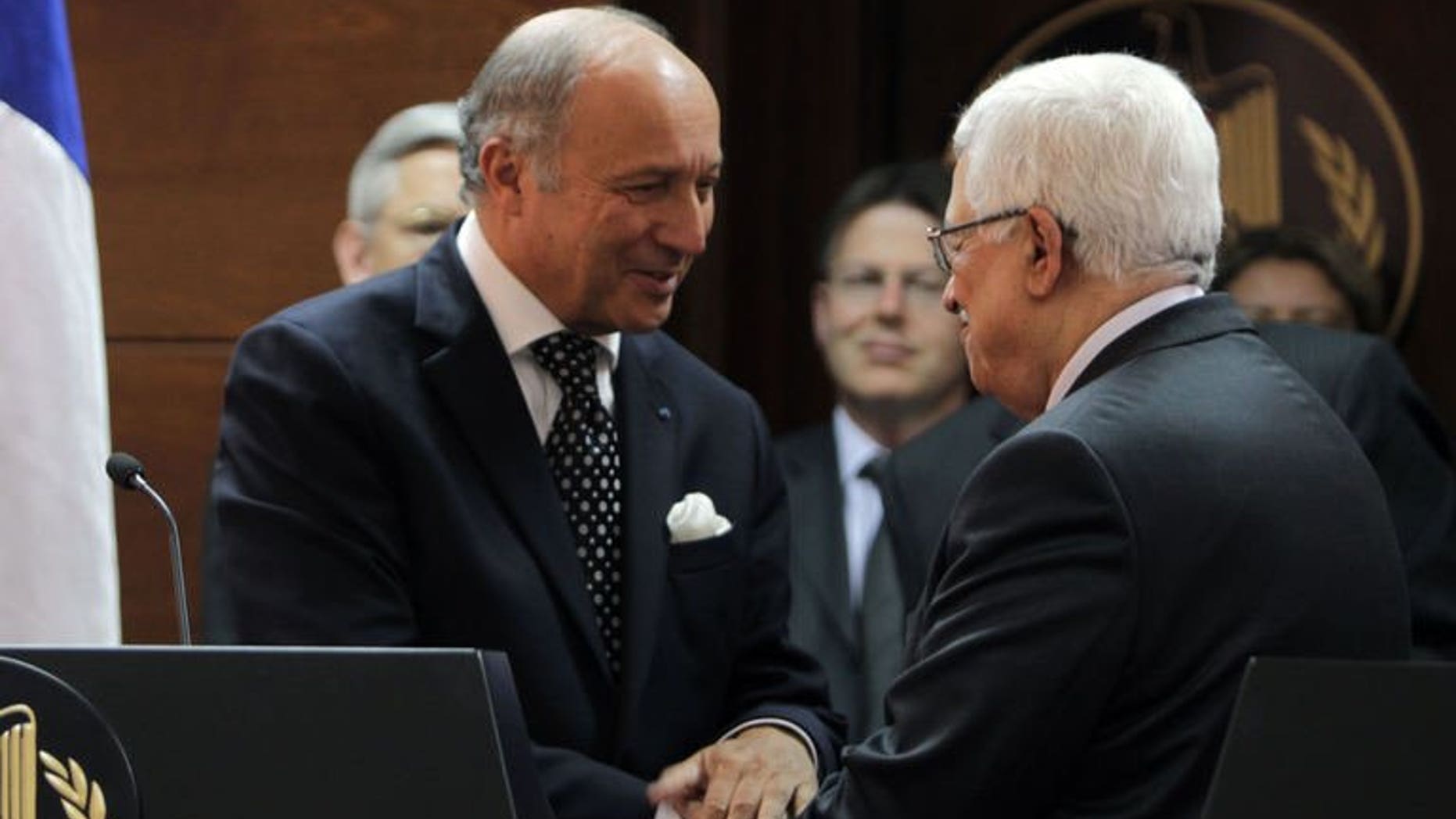 French Foreign Minister Laurent Fabius meets Palestinian President Mahmoud Abbas (R) on August 24, 2013 in Ramallah, the West Bank. A succesful outcome to the Israel-Palestinians negotiations would be like a "thunderbolt" for peace in the crisis-ridden Middle East, Fabius said.