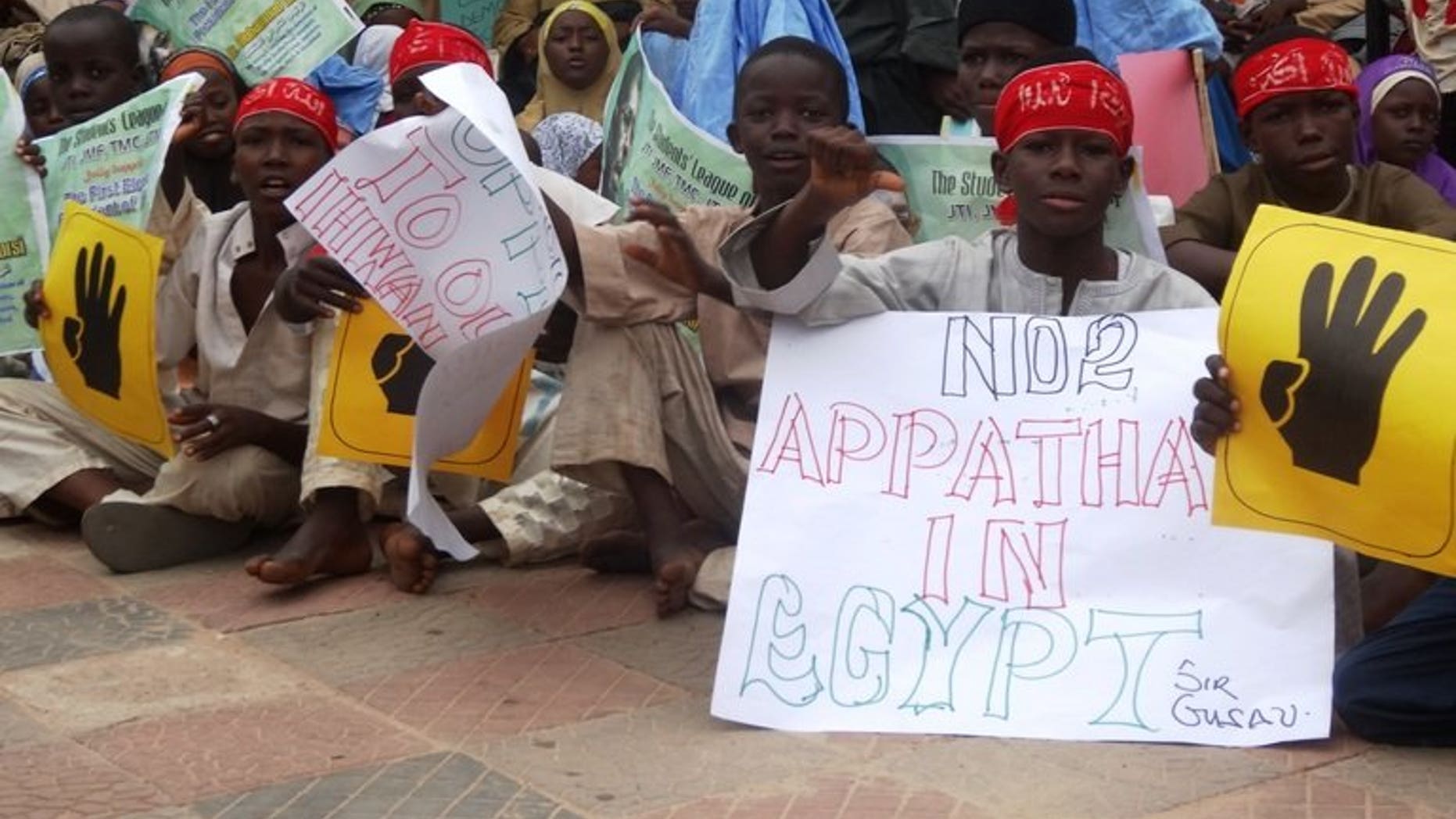 Young boys hold pro-Morsi placards during a protest on August 24, 2013 in Sheikh Ahmad Tijjani mosque, Kano, Nigeria. Thousands rallied peacefully in northern Nigeria to demand the return of Egypt's Islamist former president Mohamed Morsi, ousted by the military early last month.