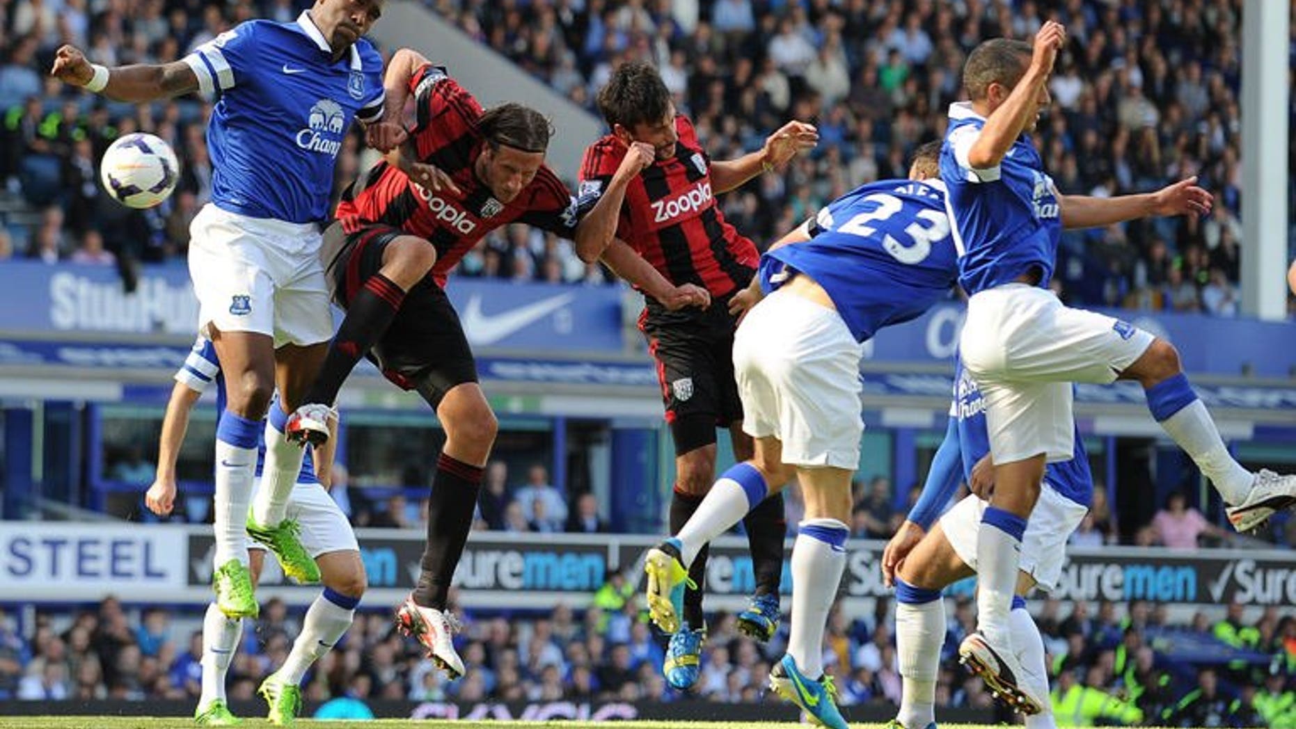 Everton's French defender Sylvain Distin (L) vies with West Bromwich Albion's Swedish defender Jonas Olsson (2nd L) during the English Premier League football match between Everton and West Bromwich Albion at Goodison Park in Liverpool on August 24, 2013. The game ended 0-0.