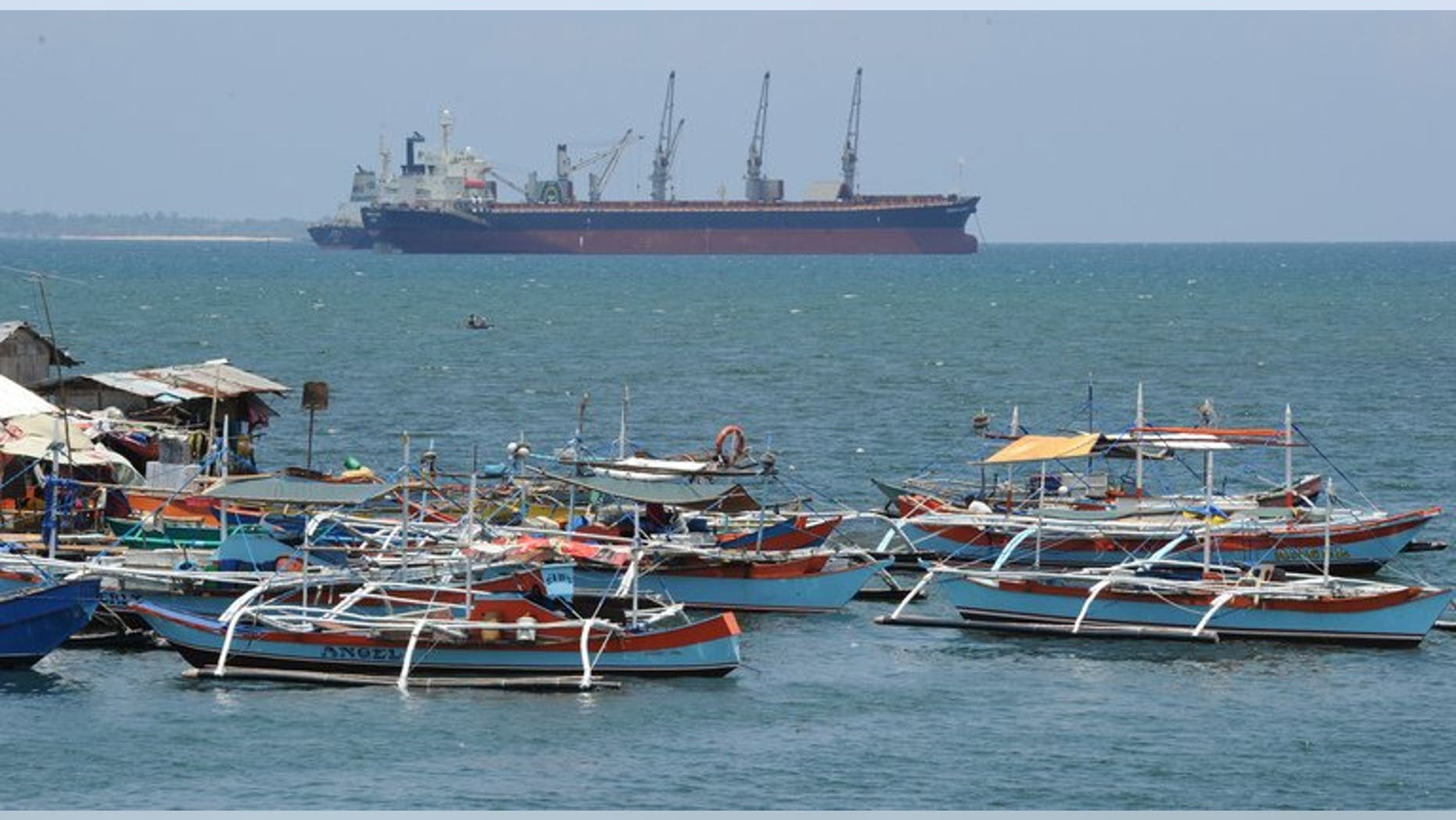 Philippine fishing boats are anchored near a foreign cargo vessel facing the South China sea at the port of Santa Cruz, Zambales province, north of Manila on May 10, 2012. The United States and the Philippines have vowed to maintain freedom of navigation in a Southeast Asia increasingly beset by maritime territorial rows, the two military allies said.