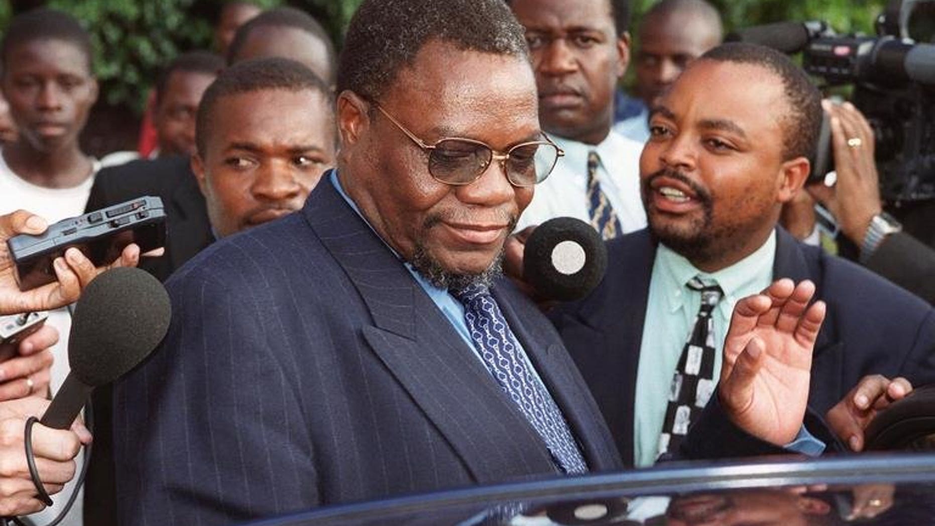Zimbabwe's then Minister of Land and Agriculture Kumbirai Kangai leaves Harare Magistrates Court March 21, 2000. Kangai, a close ally of President Robert Mugabe and key leader in the fight to end British rule, died Saturday, a party official said.