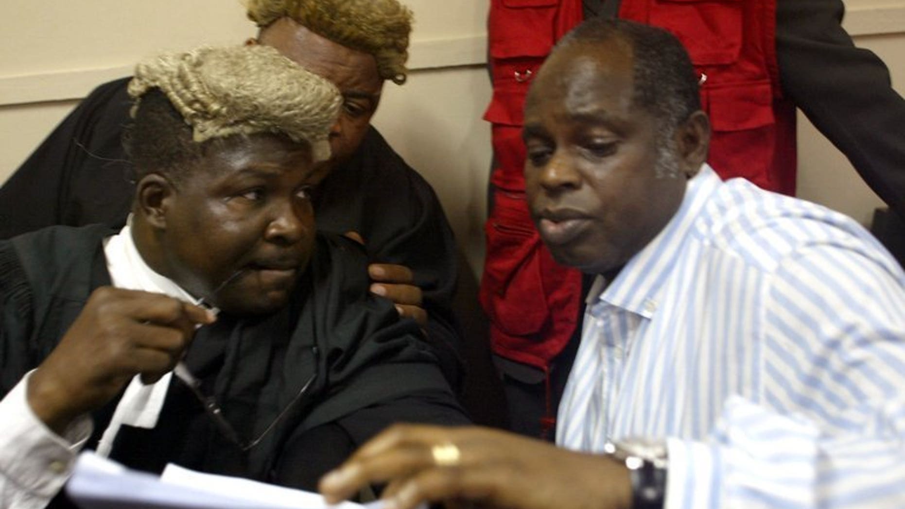 Lawyer Mike Ozekhome (L) chats with client Diepreye Alamieyesiegha on December 20, 2005, in Lagos. Gunmen have kidnapped the prominent lawyer and social critic in southern Nigeria in an apparent ransom bid, a colleague and police said Saturday.