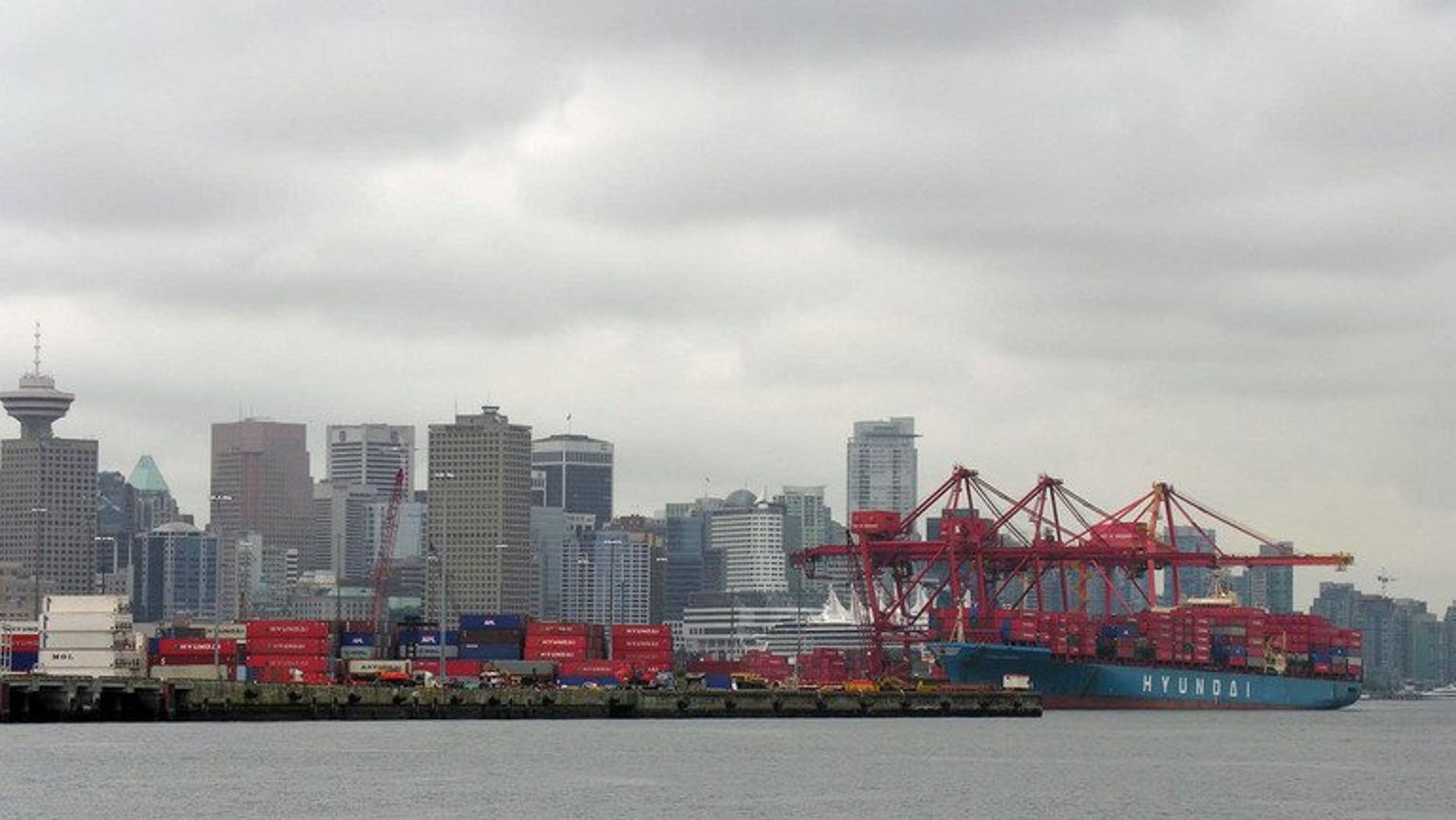 A container ship unloads in 2005 at the P&O Central Terminal in the Port of Vancouver. Canada's trade deficit doubled in July as imports increased and exports declined, the government statistical agency said Wednesday.