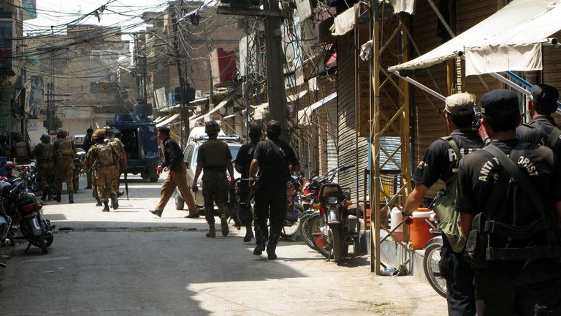 Pakistani soldiers patrols the streets of Bannu, on July 16, 2012. A bomb has wounded 11 people, mostly children, when it exploded outside a Pakistani girls' school in Bannu, a doctor has told AFP.