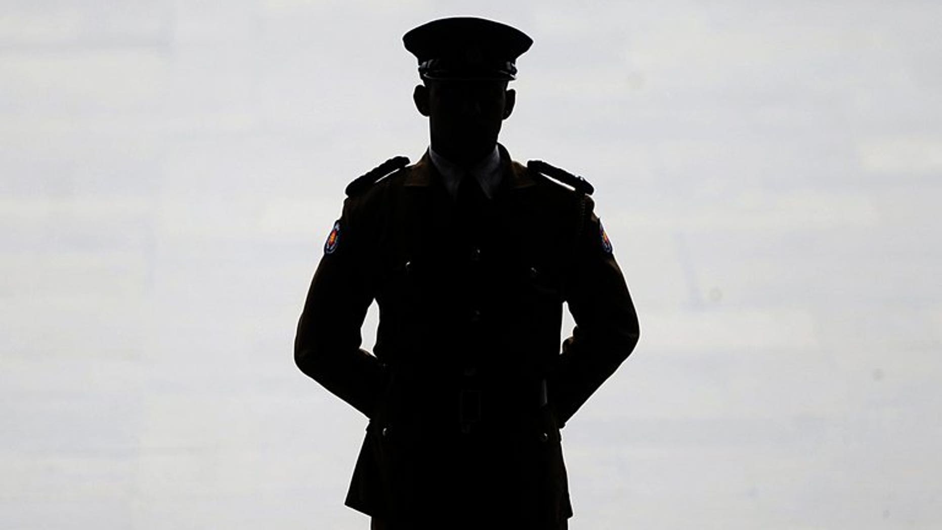 A Sri Lankan police official keeps watch in Colombo, on May 31, 2013. Sri Lankan police say a man died after a bizarre and botched ritual to drive out what he thought were evil spirits from a house outside Colombo.