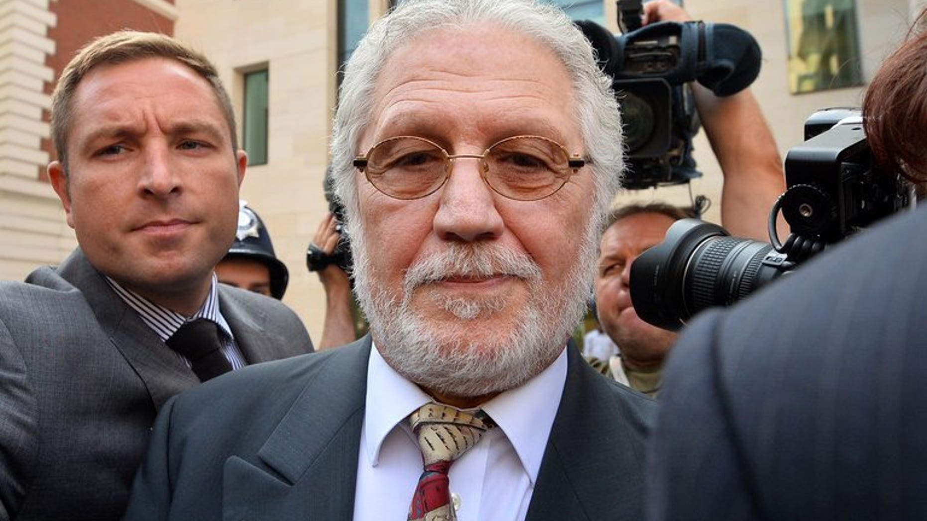 Dave Lee Travis leaves Westminster Magistrates Court in central London on August 23, 2013. The radio presenter is due to appear at crown court later charged with committing 11 indecent assaults and one sexual assault.